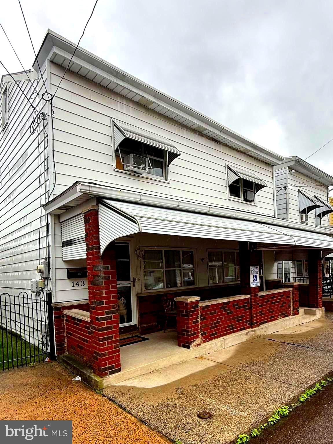 Well maintained home is located in the Borough of Saint Clair. The property comprises two distinct parcels of land, each offering ample space, and is being sold together for a single price. The home features two living rooms, a dining room, two fully equipped kitchens, two complete bathrooms, a sunroom with an enclosed patio that serves as additional heated living space, and five full bedrooms. Additionally, the laundry facilities are conveniently located on the main floor. The rear yard offers ample space for outdoor relaxation, and includes a convenient shed for gardening supplies.