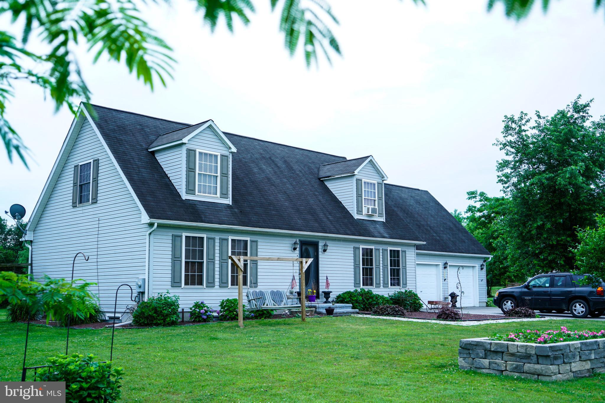 This charming 2-story Cape Cod home on 2 acres features 1 bedroom on main level with full bathroom & 2 bedrooms on second floor with a full bathroom, partially finished basement with plenty of space for added living area, attached 2-car garage with a paved driveway, mature  & a retractable awing over the rear deck.