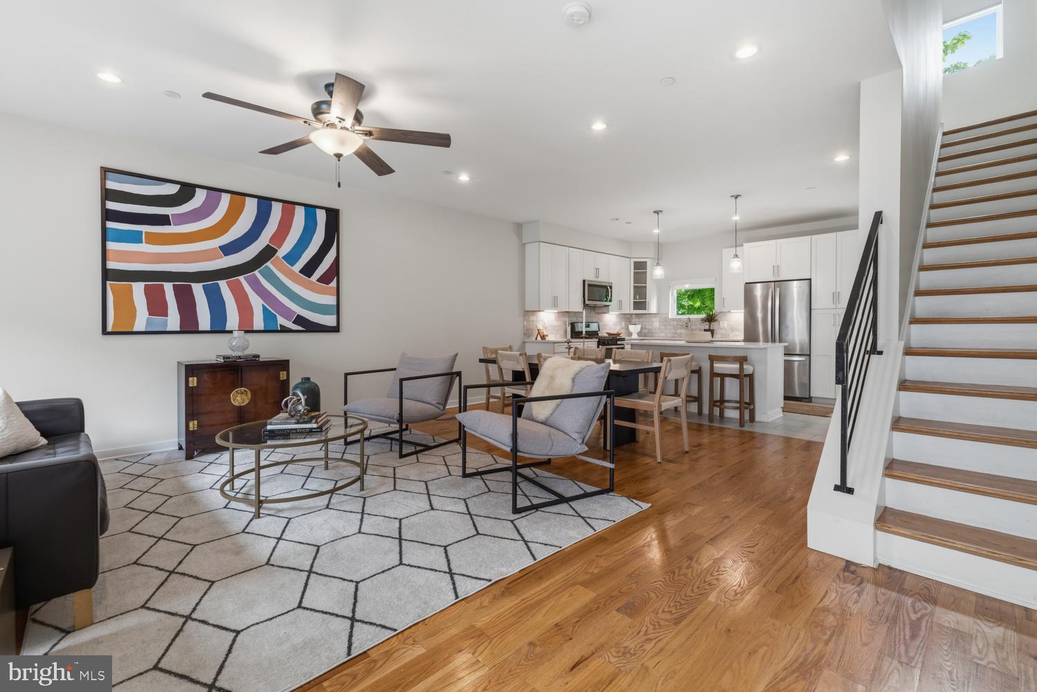 With approximately five years of tax abatement remaining, this Pipers Glen townhouse offers an exceptional financial advantage in one of Philadelphia's most coveted neighborhoods, delivered at a price that's genuinely unbeatable. Whether you're seeking a sophisticated primary residence or a smart investment in a highly walkable, transit-accessible location, this move-in-ready home checks every box. The main level is an entertainer's dream, with an open kitchen, dining, and living room flooded with natural light through oversized windows; the kitchen features high-end Whirlpool stainless appliances, quartz countertops, subway tile backsplash, and a center island that anchors it all. Upstairs, two generously sized bedrooms with excellent closet storage and a full hallway bath are joined by a luxurious third-floor primary suite offering a spa-like full bath, spacious walk-in closet, and a flexible bonus space perfect for a home office, library, or den. The finished basement extends your living space with a dedicated laundry room, full bath, and wide-open potential for a gym, media room, or storage. Crown it all with a green roof deck offering sweeping city and Germantown Ave views. Hardwood floors, quartz throughout, large soaking tubs, instant hot water, high-efficiency HVAC, and a dedicated parking spot round out the amenities. Plus, the entire exterior, including stucco, brick, metal coping, and roof, has been fully renovated with a transferrable warranty to you. Step outside to cafes, shops, restaurants, and a gym along Germantown Ave, with the library and supermarket practically next door, Wissahickon Valley Park's trails moments away, and an easy commute to Center City. This is the complete package at the right price that will allow an instant equity build! Schedule your showing today.