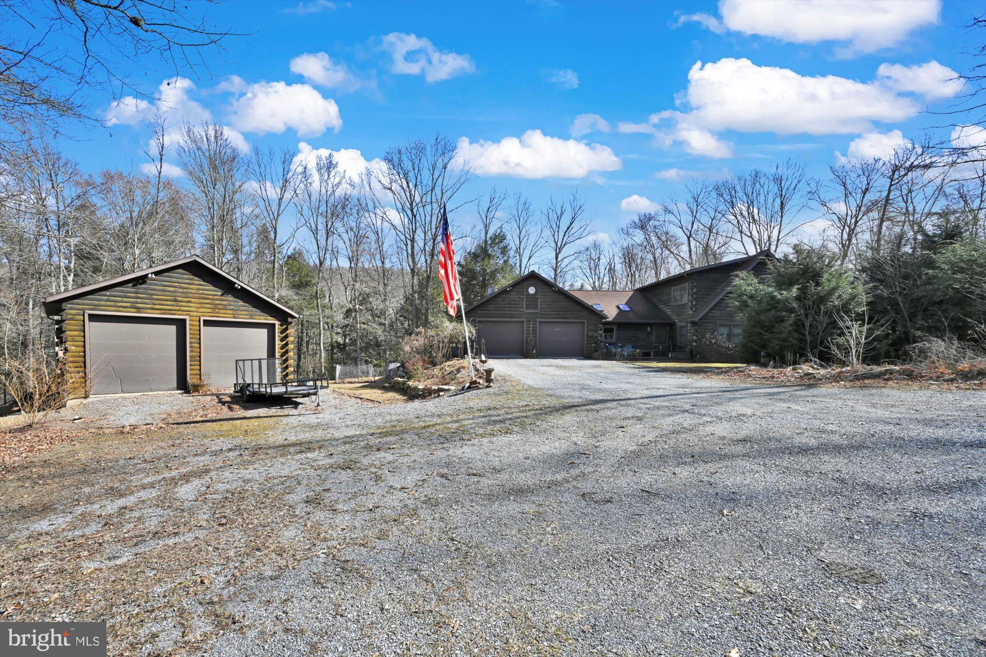 Privacy abound with this log home situated on over 10 acres. Nature surrounds you as you cross the running creek entering the drive. This beautiful log home features an open floor plan with 2 ensuite bedrooms- 1 on the main floor and another on the 2nd floor. The kitchen with solid surface counters an ample sized island has a vaulted ceiling open to the dining area. A screened porch is nestled off of the dining area... perfect to enjoy the outdoors.  The vaulted living room with exposed logs and stone fireplace is the focal point of this home.  The loft overlooks the grand living room and opens to one of the ensuite bedrooms.  An additional bedroom or office is located off of the living room.  Another ensuite bedroom is found on the 1st floor along with a half bath.  The lower level features a family room with stone accented fireplace and wet bar.  A large bedroom and another full bath are located in this area which leads to a lower level patio.  Outside finds a wrap around deck which enter the dining area and screened porch.  The attached 2 car garage with lots of storage but if that isn't enough, you will surely find it in the 2 car detached garage with 2nd story storage.  Propane generator will remain.  Property adjoins over 70 acres. Located near Swatara State Park. Easy Access to Interstate 81 & 78. Don't miss your chance to own a natures lover dream.  **Offer has been received.  Highest and Best Offers due by 12pm on 3/21/2023**