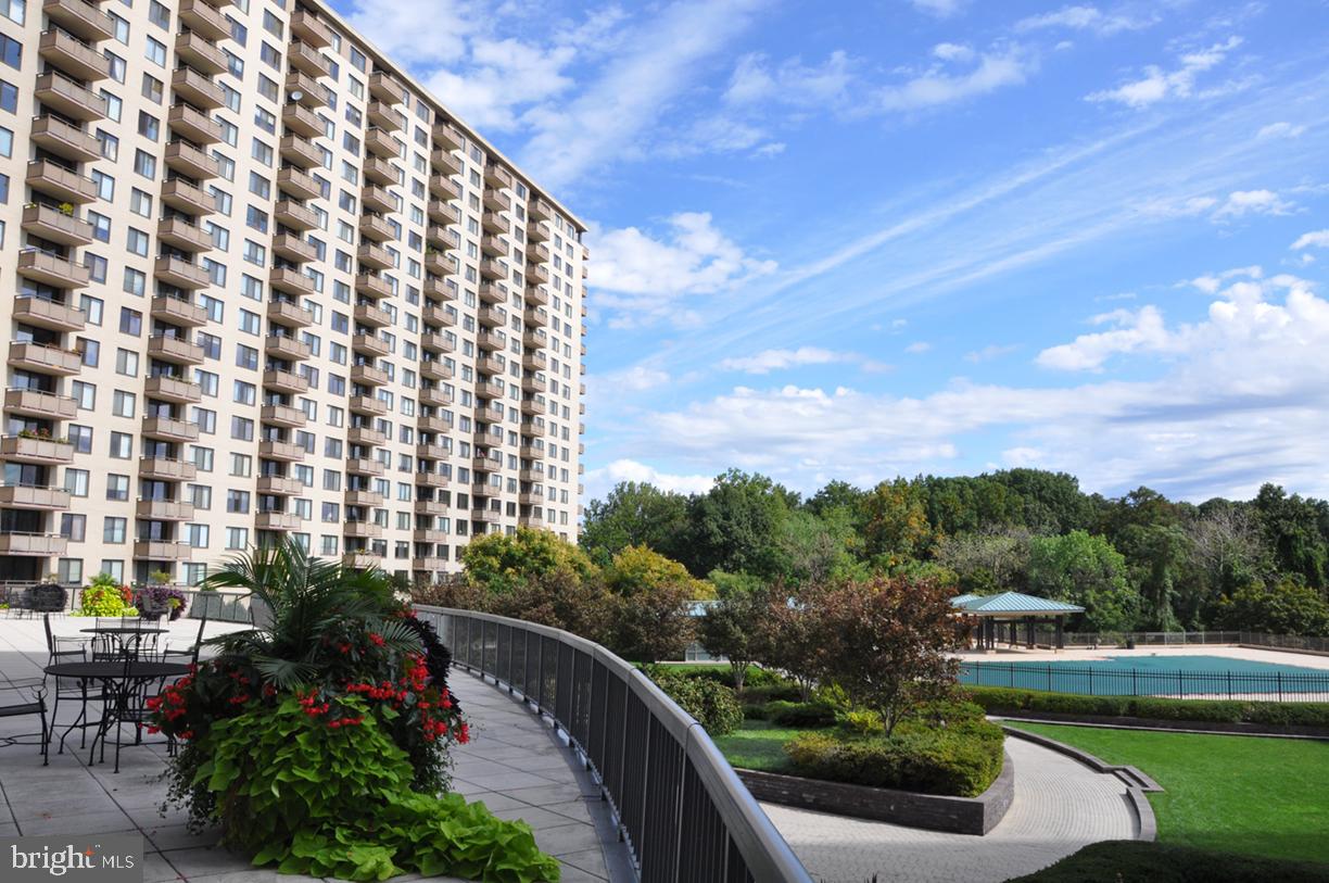 NEW PRICED IMPROVEMENT! YOU DON'T WANT TO MISS THIS! Welcome to this spacious One Bedroom One Bath in the highly desirable Promenade Towers. Bathed in natural light, this is one of the largest one bedroom apartments with 1,215 sq.ft of living space.  The expansive living room area leads to an oversized balcony overlooking both the outdoor pool and the view of trees.  Retreat to the serene bedroom complete with a walk-in closet and bathroom with linen closet.  With all utilities and property taxes included in the monthly co-op fee, homeownership is seamless and stress-free. Garage parking comes with the unit. Living at The Promenade means enjoying resort-style amenities in a beautifully maintained, park-like setting. Take advantage of the fitness center, indoor and outdoor pools with adjacent grills, tennis/pickle ball courts, walking trails, dry cleaners, beauty salon, market/deli, restaurant, 24/7 security, and more. With electric vehicle charging stations, a car wash station, and direct access to public transportation, including the Ride On Bus to two nearby Metro stations, commuting is effortless. The bus comes directly to the door of the Promenade. Close proximity to the Red Line Medical Center metro stop at NIH/Walter Reed and Grosvenor metro with easy access to 495 and 270. Nearby Wildwood Shopping Center with Balducci’s, CVS, Bethesda Bagels, Starbucks, restaurants and several boutiques and a Giant food  across the way. Don’t miss the opportunity to own this exceptional home in one of Bethesda’s most sought-after communities!