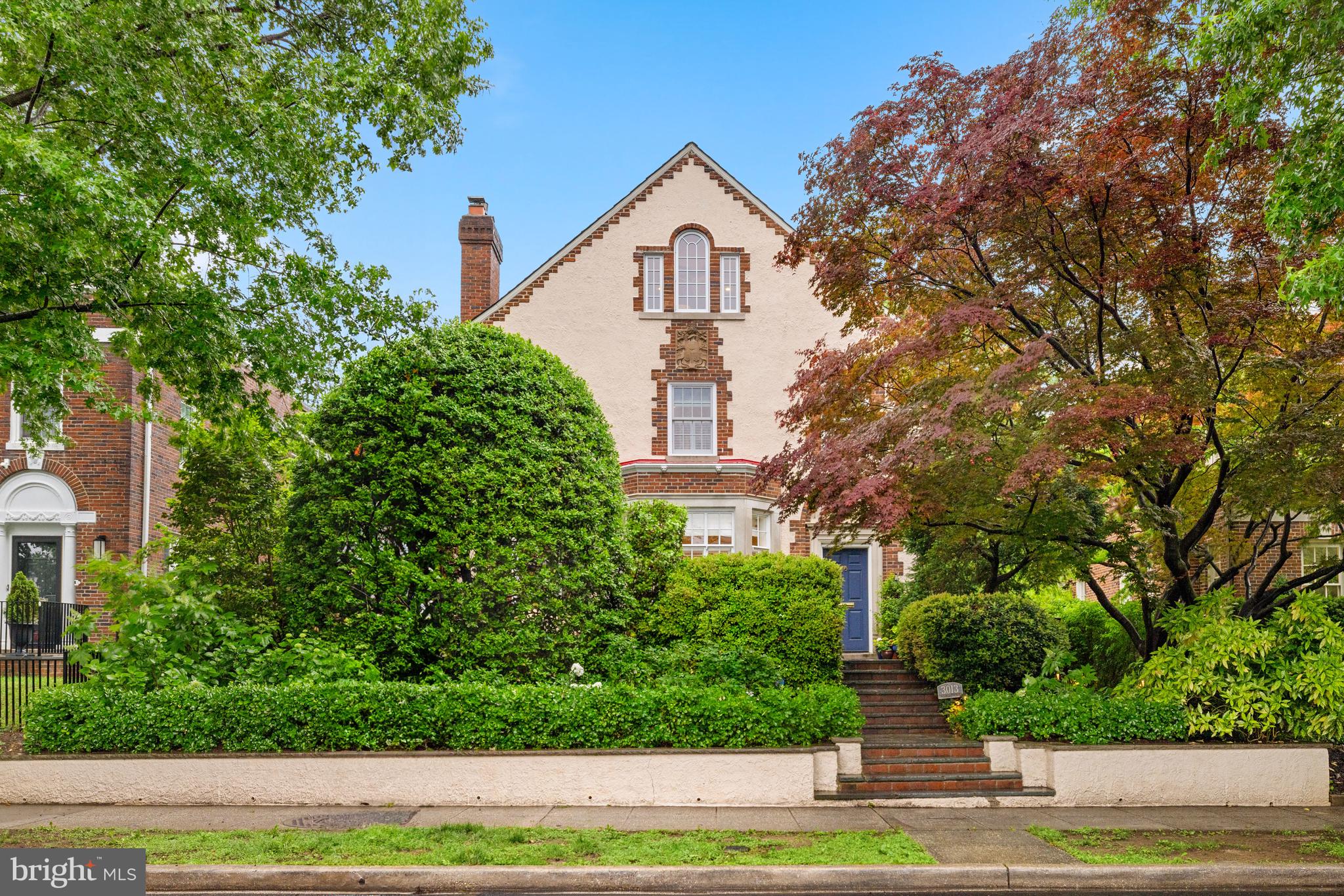IMMACULATELY RENOVATED detached Wardman home in ideal Woodley Park location walkable to schools, shops, restaurants, and Metro! Handsome facade with intricate limestone details reveals an airy floor plan with large scale rooms and lovely social flow to multiple private outdoor spaces - all thoughtfully and meticulously renovated with many enchanting period details preserved! Main level features large foyer with inviting curved stairway, deep coat closet, and powder room; arched entrance to spacious living room with fireplace and bay window with window seat, elegant dining room, and stunning chef's kitchen open to family room, which all flow seamlessly to lovely landscaped private front patio, rear with deck with awning, and private back garden. Second level features expansive primary suite featuring bedroom with fireplace, beautiful bathroom, and large custom dressing room; two additional bedrooms, and a full bathroom. Lofty third floor features open flex office/family/play room, full bathroom, laundry room, and bedroom with Palladian window and cedar closet. Semi-finished basement has plenty of storage space and is renovation-ready with comfortable ceiling heights and another half bathroom. Easy parking with garage and additional driveway parking accessed from rear alley.