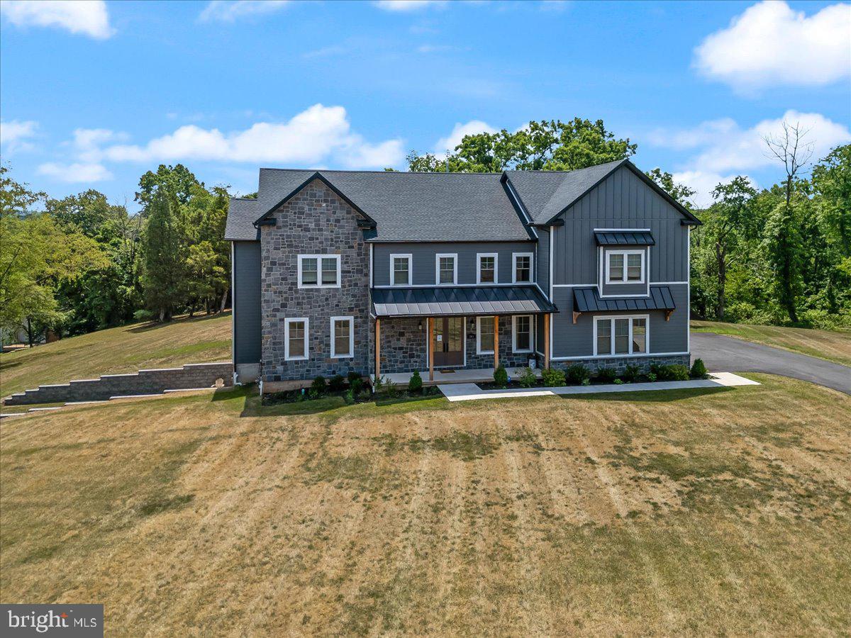 Welcome to 143 Hopwood Rd, located in Upper Providence Township in the highly desirable Spring Ford School District. This less than 2 year old home is situated on a private 1.7 acre lot just minutes away from shopping and restaurants at the Providence Town Center, King of Prussia Mall, Rts. 29, 113, 422 and so much more! This modern Farmhouse style home has over 4,372 above grade square feet of open concept living, featuring vaulted ceilings and a gas fireplace. In addition to 6 bedrooms, 4 full and 1 half bath,  the home also features a finished walkout basement and a three car garage. The walk-out basement includes the 6th bedroom, full bathroom, living area, washer/dryer and kitchenette/wet bar area.  This 1,000 foot area could easily be used as an inlaw or au pair suite. The garage leads to a convenient mud room with custom built cubbies for the kid’s backpacks and supplies.  The gourmet kitchen includes an oversized island with seating, built in microwave, stainless appliances, an extra large farm house sink and quartz countertops.  Perfect for entertaining friends and family! Directly off the kitchen you will find a butlers pantry along with a massive pantry with built in shelving. There is also a separate dining room off of the kitchen for those holiday meals. You’ll also find a bedroom on this level. This beautiful home is accented with KAHRS hardwood floors, 10' first floor ceilings and recessed lighting throughout. Upstairs you'll find 2 master suites both with a full bath and 2 additional bedrooms , 1 bath and laundry room.  Siding is HardieBoard and stone with 30 year GAF architectural shingles. In addition to the many upgrades, the owners recently added a custom partially covered deck and patio, whole home filtration system, Ecobee thermostat, custom closets, ADT home security package with google home, custom shades and custom kitchen cabinets.  Home includes a passive radon system. Don’t miss the opportunity to make this stunning home yours before the school year begins!