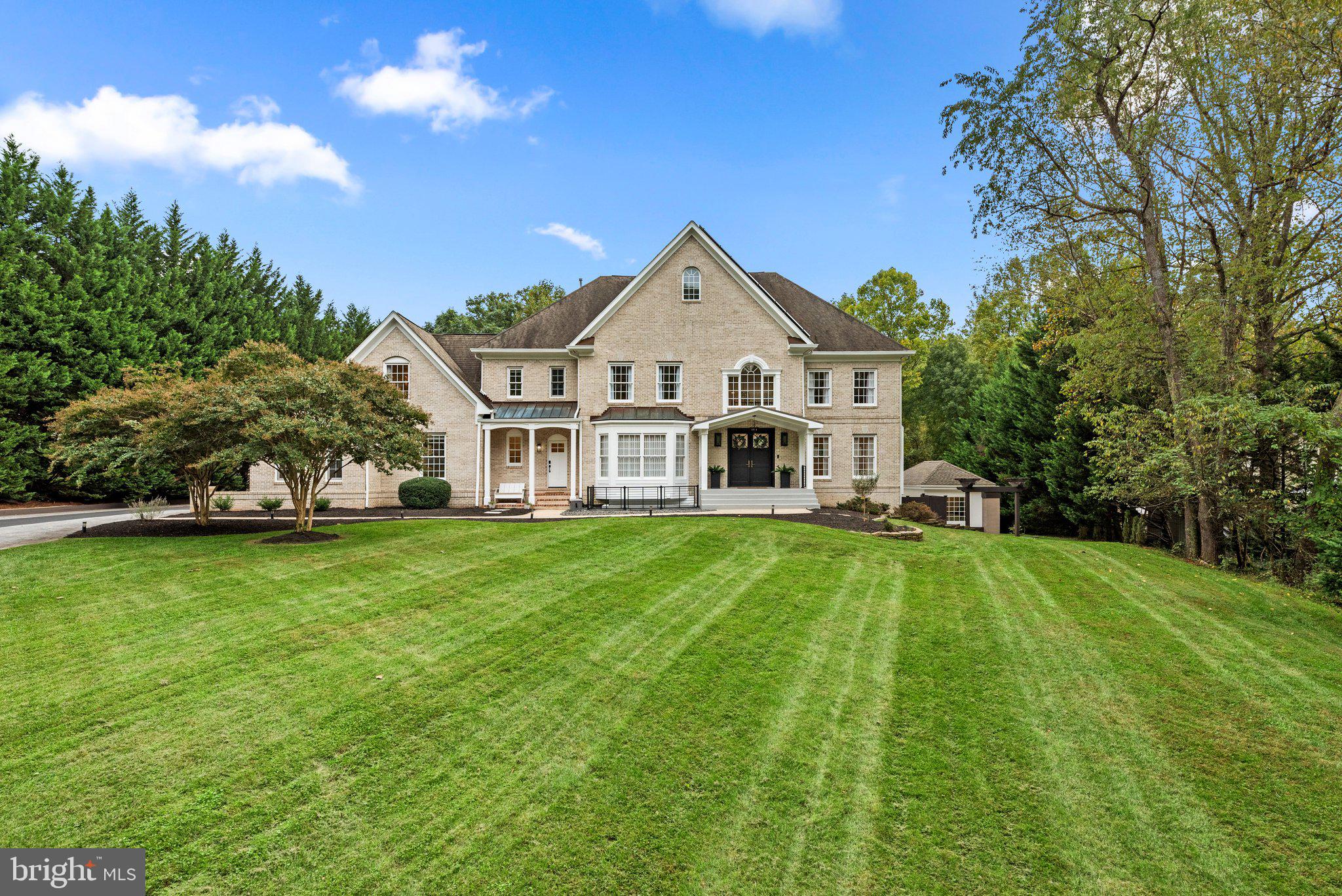 Custom Masterpiece with close to $1M in Renovations!
Introducing a stunning custom home boasting 7,577 of finished square feet for luxurious living.  With 7 bedrooms, 5 full baths, and 2 half baths, this residence is an entertainer’s dream on 1.41 private acres. This exquisite home combines elegance, functionality, and modern amenities in a prime location.  With its dramatic appeal and spectacular flow it is perfect for entertaining on a grand scale or just relaxing in the tranquil privacy.  It has multi-level covered decks with skylights, private upper floor deck, and massive ground level terraces.  Entering the elegant double front doors you will find a dramatic two-story foyer with a graceful curved staircase and natural light radiating from every angle. The grand foyer is bordered by an immense dining room with beautiful bay window and living room (featuring a gas fireplace). There is also a bedroom/office on this level. The family room features built-ins, soaring floor to ceiling fireplace flanked by a wall of windows with access to the covered deck. The massive eat-in gourmet kitchen features Thermador stainless appliances, double wall ovens, built-in microwave, a huge island with Dekton Countertop imported from Spain, two oversized sinks and two dishwashers.  Beautiful high-end custom cabinetry abounds with unique storage systems. You will also find a second staircase leading to upper level and access to the covered deck.  The well-appointed mud room with separate outside entrance has loads of custom cabinetry, two sinks, washer and dryer.  The upper level features a spectacular owner’s suite with a gorgeous bathroom, fabulous custom closets and a private deck.  There are three additional large bedrooms on this level, one with a beautifully renovated bath and two that share a Jack/Jill bath.  The lower level haven includes a second kitchen equipped with wine refrigerators, built-in coffee maker, sink, dishwasher, custom cabinetry and Dekton countertops.  The large family room has a gas fireplace and lots of options for seating and entertaining areas with access to outdoor terrace.  There is an additional recreation area with custom shelving and lots of windows.  Two large bedrooms, two full baths and one half bath on this level as well as a second washer and dryer.  The oversized 3-car garage boasts new doors and motors and includes extra closed storage and an EV charger.  You will also enjoy a separate private gym just steps from the main house with hot tub just outside.  20KW Generac Automatic Generator included.  Solar panels owned.