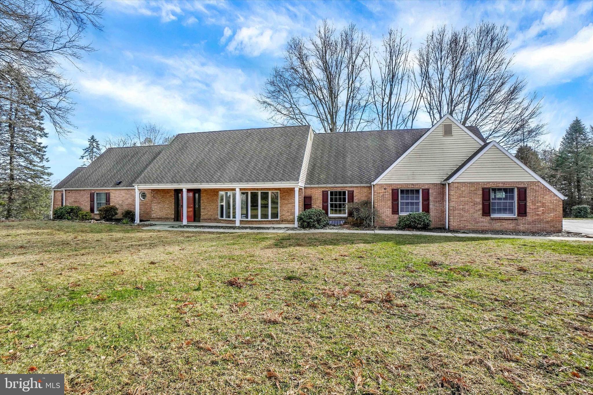 Welcome to 94 Stone Mill Road, an exceptional 1.5-story home on 6.5 scenic acres, offering over 5,500 sq. ft. above grade plus 1,000 sq. ft. of finished lower-level living. A long private driveway leads to the home, surrounded by mature trees, open fields, and thoughtfully landscaped plantings, a rare opportunity to own this amount of acreage in the Hershey/Hummelstown area.
Step inside and find modern LVP flooring through the foyer, kitchen, dining room, living room, and family room. The family room features a cozy wood-burning fireplace, while the living room showcases a bright bay window. The updated kitchen includes stainless steel appliances, granite countertops, and tile flooring, which continues into the heated sunroom, where you’ll enjoy expansive nature views and spectacular sunrises over the surrounding fields and woods.
The first-floor primary suite offers a walk-in closet and a newly tiled shower, plus a bonus room perfect for a nursery, office, or sitting room. A second full bath with LVP, a half bath, and a convenient laundry room off the garage complete the main level.
Upstairs are three additional bedrooms, all with carpet and generous closets, including two with walk-in closets, and plenty of storage throughout, along with a full bathroom.
The fully finished lower level offers excellent flexibility with in-law/guest quarters, featuring a full kitchen with granite counters, bedroom, full bath, tile floors, second wood-burning fireplace, living area, laundry hookup, and walkout access to the property.
Car enthusiasts and hobbyists will appreciate the 5-car garage capacity, including an attached garage and a detached 3+ car garage/barn with a new roof, siding, windows, and garage doors, plus a loft ideal for storage, workshop, or hobby use.
Additional updates and features include new first-floor windows, refreshed siding, four heating systems, fenced yard space for pets, upgraded bathrooms throughout, and plenty of room to garden, enjoy wildlife, or even keep horses.
A rare blend of space, privacy, and versatility—just minutes from Hershey attractions, Penn State Hershey Medical Center, Hummelstown shops and events, and convenient Harrisburg commuter routes.

Future Opportunity: The 6.5 acres include two approved tracts under one deed. The additional 3-acre tract is formally approved, perced, probed, and septic permitted, allowing for a potential additional dwelling. Tax records currently reflect a single parcel—buyer to verify intended use.

A one-of-a-kind property offering land, comfort, privacy, and value—a must-see!
Upstairs are three additional bedrooms, all with carpet and great closet space, with two featuring walk-in closets, along with abundant storage tucked throughout and a large full bathroom.
The fully finished lower level offers endless possibilities with its in-law/guest quarters, complete with a full kitchen with granite counters, bedroom, full bath, tile floors, second wood-burning fireplace, living area, and laundry hookup, plus walkout access to the yard.
Car lovers and hobbyists will appreciate the 5-car garage capacity, an attached garage plus a detached 3+ car garage with walk-up loft perfect for storage or workshop space.
Additional features include brick and vinyl exterior, fenced side yard for pets, and four heating systems for comfort and efficiency.
A rare blend of space, privacy, and flexibility, just minutes from Hershey amenities, schools, and commuter routes. A one-of-a-kind property offering land, comfort, privacy, and value, a must-see!

Great future potential: Property included two approved tracts under one deed totaling 6.5 acres. The additional 3 acre tract has been formally approved, perced and probed with septic permit issued, allowing for potential future dwelling. Tax records reflect a single parcel. Buyer to verify intended use.