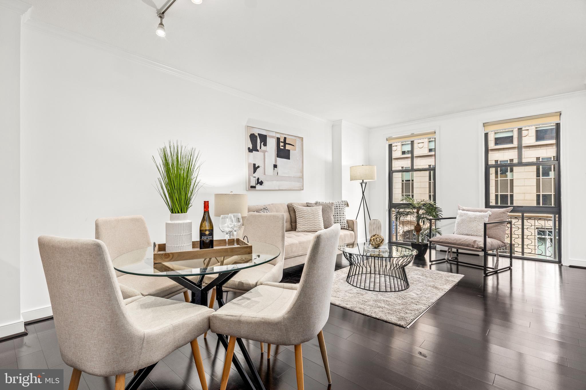 Welcome to the Clara Barton—a premier, highly sought-after residence in the heart of Penn Quarter! This freshly painted one-bedroom unit boasts beautiful hardwood floors and tall windows that fill the space with natural light. The open-concept layout offers versatile living and dining areas, perfect for modern living. The kitchen is well-appointed with ample cabinetry, granite countertops, stainless steel appliances, and a functional island that’s ideal for casual dining or entertaining. The spacious bedroom features abundant sunlight and a generous walk-in closet, while the oversized bathroom adds an extra touch of comfort. An in-unit washer and dryer make daily living even more convenient. The Clara Barton offers resort-style, pet-friendly living with an impressive suite of amenities, including a rooftop deck with a pool, grilling and dining areas, and iconic DC views. Residents also enjoy access to a private courtyard with a fountain, 24-hour front desk, business center, conference room, 30-seat theatre, party room, and fully equipped fitness center. Garage parking is available for rent. Located in vibrant Penn Quarter, you're just steps away from top-tier dining, world-class museums, theaters, the National Mall, and access to all Metro lines—offering the ultimate urban DC lifestyle.
