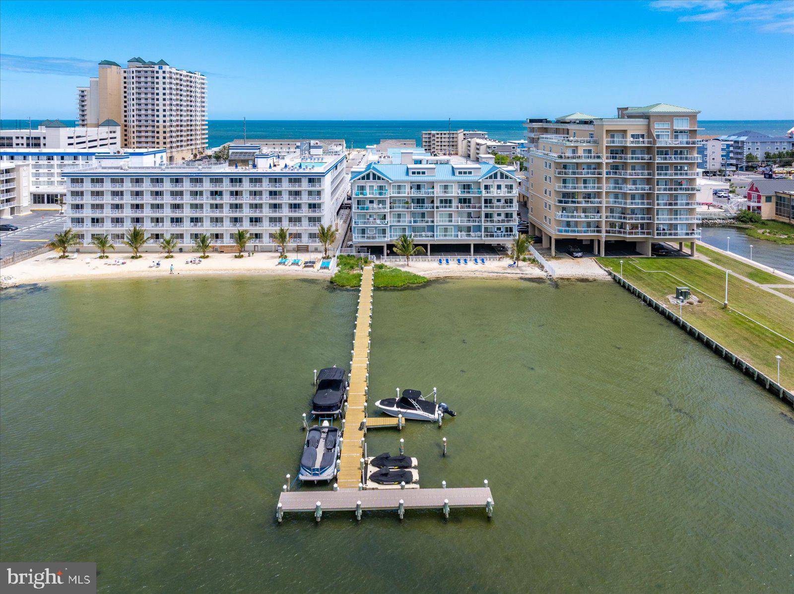 Welcome to Unit 205 at Sunset Beach, a spacious bayside retreat with resort style amenities ideally located in the heart of midtown Ocean City. This beautifully maintained 2-bedroom, 2-bath condominium offers approximately 1,600 square feet of comfortable coastal living, featuring a large private balcony overlooking the bay—an ideal setting for morning coffee, outdoor relaxation, and taking in Ocean City's spectacular sunsets.

The expansive living and dining areas flow seamlessly to your private balcony where you can enjoy stunning sunset skies and refreshing bay breezes. The well-appointed kitchen provides ample cabinetry, generous counter space, newer appliances and a breakfast bar for casual dining.

The oversized primary suite offers a peaceful escape with balcony access, a walk-in closet, and a private bath featuring soaking tub, double sink vanity and stall shower. A spacious guest bedroom with balcony access and second large full bath provide comfortable accommodations for family and friends.

Built in 2007, the sought-after Sunset Beach community offers an exceptional amenity package, including a rooftop pool with spectacular views, a private sandy beach complete with palm trees and lounge chairs, a private pier, beautifully maintained atrium-style common area, secured coded entry, exterior security cameras, elevator access, and a private storage closet conveniently located directly next to the unit. For added convenience and value, unit 205 is being sold furnished, includes two assigned parking spaces and has newer HVAC and water heater. 

Whether you’re searching for a primary residence, vacation getaway, or investment opportunity, this property offers the perfect blend of space, location, and coastal lifestyle.

Experience the best of Ocean City living from this exceptional midtown condominium one block from the beach and just steps from dining, shopping, and entertainment.