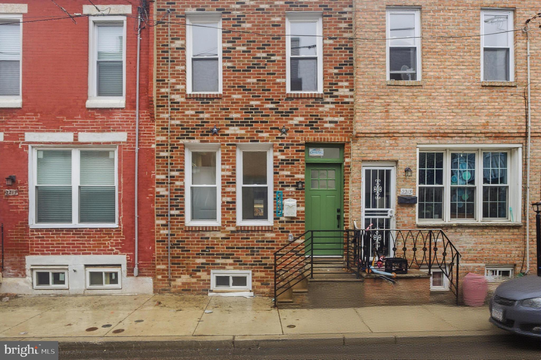 Welcome to this beautifully updated row home located in the vibrant Point Breeze neighborhood of South Philadelphia. This charming open-concept home features sturdy hardwood flooring and recessed lighting throughout, creating a warm and modern atmosphere.  A thoughtfully designed half bathroom is conveniently located on the first floor, featuring a stylish sage green vanity, modern lighting, and a window that fills the space with natural sunlight. The kitchen is a standout, featuring new stainless steel appliances, beautiful sage green lower cabinets paired with crisp white upper cabinets, and workspace for meal prep. Just beyond the kitchen, step out to a fenced-in cement yard. Upstairs, are three bedrooms and a newly renovated full bathroom. The primary bedroom features a charming exposed brick column accent and ceiling fan, adding character and comfort to the space. The bathroom has been newly remodeled, continuing the home’s stylish theme with sage green cabinetry, black fixtures, and a shower/tub combination. This home is thoughtfully designed with a functional layout and is move-in ready. This home is located in an area eligible for programs such as Philly First Home, PHFA, and additional grant opportunities. We work with trusted lender partners who can provide detailed information and help you explore all available grants to support your purchase. Don't miss the opportunity to own a home in the bustling Point Breeze section of South Philadelphia. Schedule your showing today!
