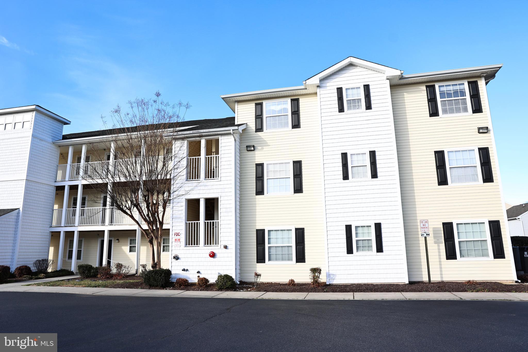 Welcome to living in the Villages at Millwood! This building includes an elevator to take you to this beautiful 3-bedroom, 2-bath third-floor unit. It offers a bright and open layout designed for both comfort and convenience. Step inside to find an open-concept kitchen and living room, perfect for everyday living and entertaining. The kitchen features a center island with bar seating, providing the ideal spot for casual meals or gathering with friends. Just off the living room, a sliding glass door leads to the four-seasons room, offering additional living space to enjoy year-round and views of the pond. The spacious primary suite includes a private bath with dual vanity sinks, while two additional bedrooms share a full hallway bathroom—perfect for guests, a home office, or extra space. This building includes an elevator to take you to the third floor unit. Enjoy a prime location close to shopping, dining, and all that Millsboro has to offer—schedule your showing today!
