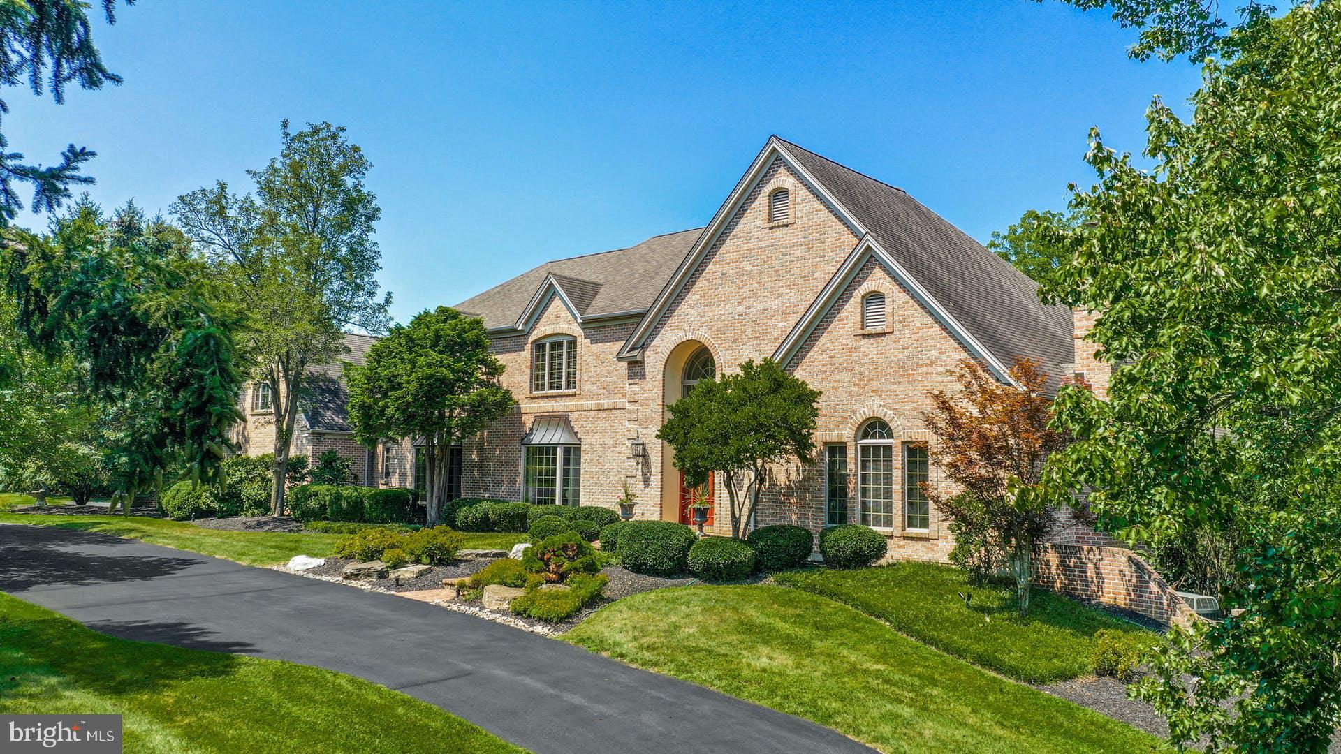 PRICE REDUCED! Come for the SVCC Senior Golf Open in June!  This Saucon Valley property, elegantly positioned on a private cul-de-sac is graciously approached by a circular drive.  Set amidst rich landscaping, on a park-like three acres, the home is oriented to take in the beauty of the surroundings. Inside, the timeless design offers a floor plan featuring extraordinary window placement and spacious rooms in more than 7,040 square feet on three levels. A wealth of custom details and a sophisticated, yet functional, floor plan attest to the thoughtful design. Romantic details combine with marble, wood and tile accents to create a rich and warm atmosphere in spaces that invite one to entertain. The family room, highlighted with hardwood flooring, wet bar and fireplace, offers an inviting ambiance. A handsome library features a deep coffered ceiling, fireplace, and walls of paneled oak and custom cabinetry. The gourmet kitchen was designed as the heart of the home and plays its part with ease, with a sun-filled breakfast area to enjoy the outside greenery. A first-floor primary bedroom suite has a stunning marble bathroom with whirlpool tub. The second floor, with front and back stairs, has multiple bedrooms, theater room and a skylit bonus room for family, guests or au pair. But it is the fully finished lower level that invites guests and family to relax and enjoy. There are many rooms, offering a variety of uses, including a custom bar, second office, wine cellar and TV, game and billiard rooms.