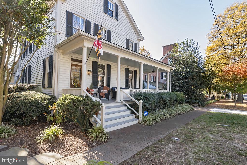 Discover this charming historic home in the heart of St. Michaels, built circa 1890, where classic craftsmanship and timeless elegance come together.  Starting with the expansive wrap-around porch, you can see this home is a traditional gem.  Highlights of the home include 9ft. ceilings, hardwood floors throughout and original architectural details that define the craftsmanship. and charm. The first floor includes a private bedroom with gas fireplace, formal dining room, formal living room with wood burning fireplace, and large family room off the kitchen which is also open to the living room.  Through the back door you descend the steps to a large screened-in porch ideal for entertaining and small dinner parties.  The yard is fully fenced and includes a detached studio that is perfect as an office , artist studio or additional guest room, providing both flexibility and privacy.   The second floor features a large primary bedroom with sitting  room featuring a gas fireplace and built-ins, two additional bedrooms, and full bath. There is also the staircase for walk-up access to the attic.  This property also offers off-street parking which is a true added value to any historic St. Michaels home.  Being 1/2 block to the harbor and Talbot Street, you are just minutes to all the best St. Michaels has to offer.  Professional photos coming soon.