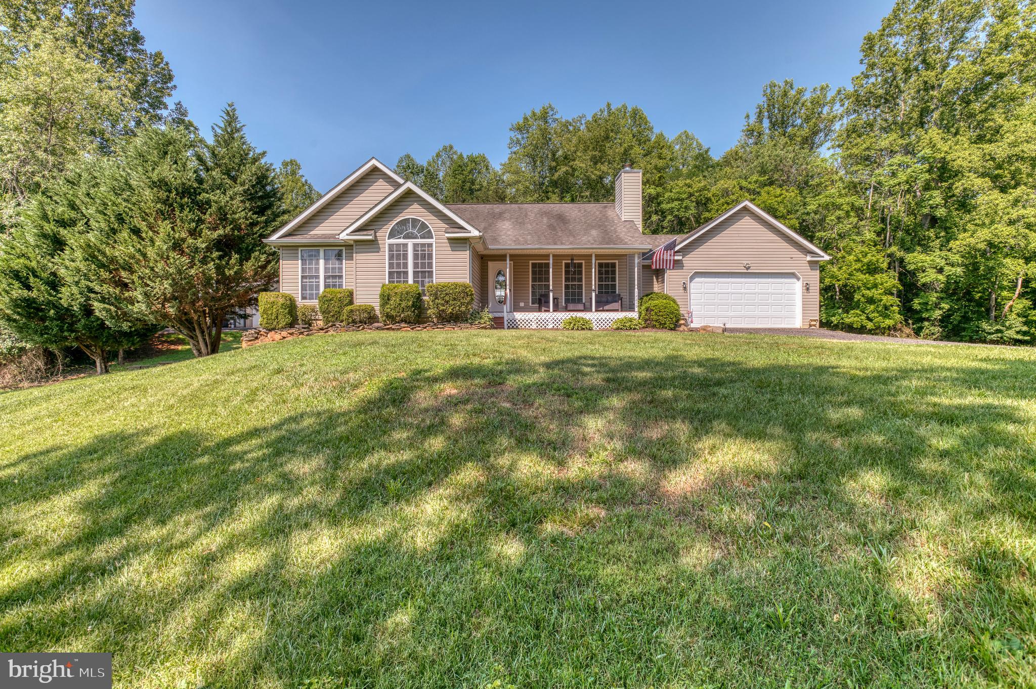 Nestled in the serene Woodland subdivision, this charming ranch-style home offers a perfect blend of comfort and functionality. Built in 2005, this well-maintained residence boasts 2,719 sq. ft. of inviting living space, featuring four spacious bedrooms and three full bathrooms, ideal for both relaxation and entertaining. Step inside to discover an open floor plan that seamlessly connects the living, dining, and kitchen areas. The upgraded countertops and built-ins enhance the kitchen's appeal, while the breakfast area invites casual dining. Recessed lighting and double-pane windows fill the space with warmth and natural light, creating a cozy atmosphere. The living room, complete with a glass-doored fireplace and mantel, serves as a perfect gathering spot. The exterior is equally impressive, set on a generous 7.66-acre lot with beautifully landscaped grounds. The basement offers an additional kitchen, family room, bedroom and bath.  Also storage areas. Enjoy outdoor living on the expansive deck or porch, perfect for morning coffee or evening gatherings.  The home offers an attached 2 car garage with storage. Additional structures, include a barn/stable with water and electric with 4 stalls, fencing for horse with a polyrope type fencing,   a large shop that is 30 x 50 with electric and water and an additional 30 amp hookup for an RV with a lean too for extra storage. Modern conveniences abound with essential appliances, including a dishwasher, microwave, and stacked washer/dryer. The gravel driveway accommodates plenty of parking. This home is not just a place to live; it’s a sanctuary where memories are made. Experience the perfect blend of comfort, style, and outdoor beauty in this delightful property.
