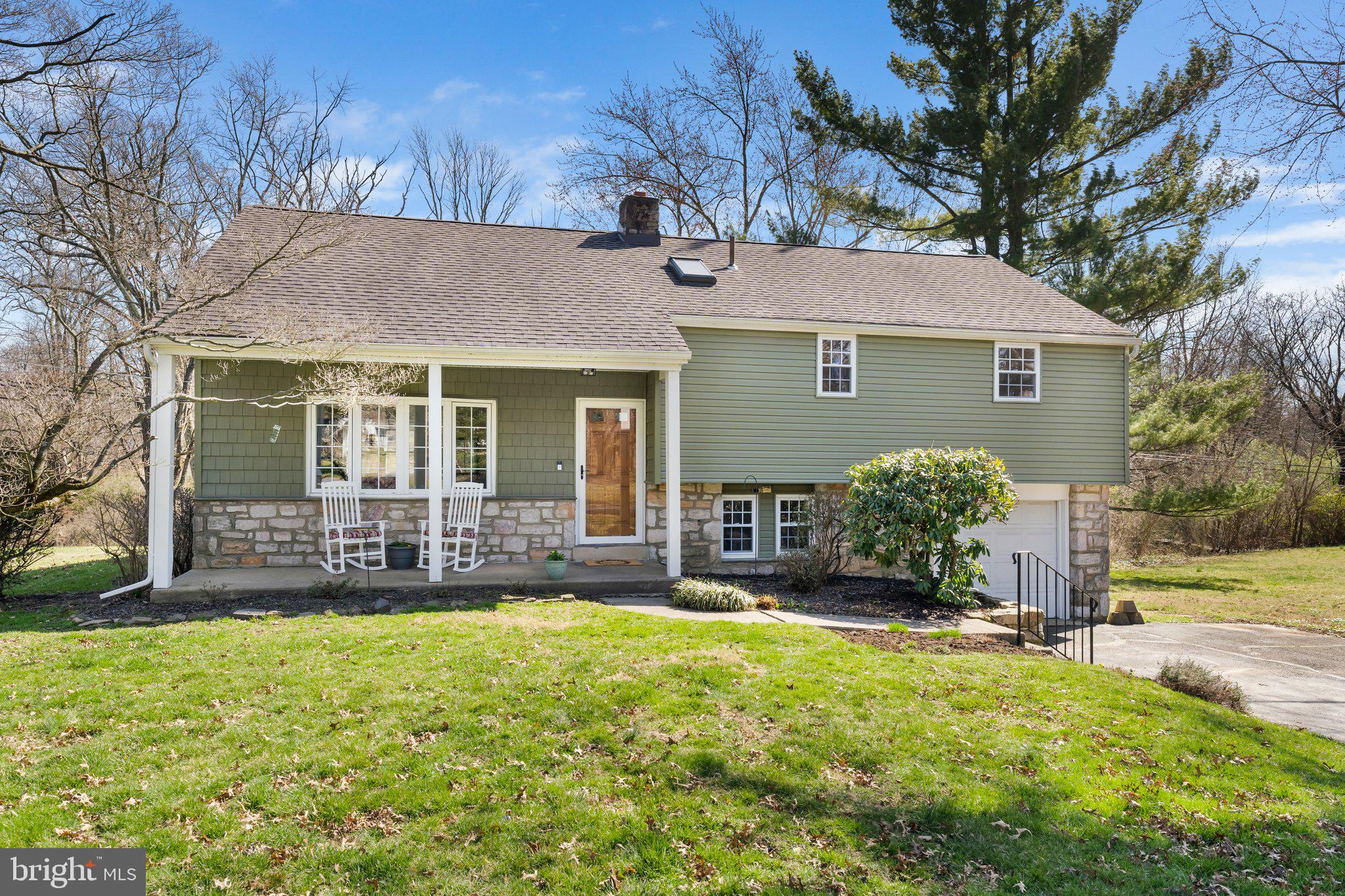 PLEASE JOIN US: Twilight Open House Thursday, 3/21, from 4 to 6 PM AND 2nd Open House Sunday, 3/24, from 1 to 3 PM.

Welcome to this stunning expanded split-level home situated in the desirable Merrybrook neighborhood of North Wales! Embracing a walkable lifestyle, this residence is nestled within a charming community known for its convenience and accessibility. Tucked back from the street with a long paved driveway, the home greets you with an inviting front porch, eye catching curb appeal, and a beautiful new front door, promising a warm welcome.

Step inside to be greeted by beautiful hardwood floors that flow seamlessly throughout the bright living room, adorned with large windows, crown molding, and ample closet space. The living room opens up to the kitchen and dining room, featuring a charming beadboard finish. The newly remodeled kitchen is a chef's delight, showcasing a large island, white cabinets with soft-close drawers, granite countertops, and sparkling stainless steel appliances including a Samsung gas stove. Enjoy the convenience of a pantry with pull-out drawers, a deep stainless steel sink, and a built-in microwave, along with recessed lighting and a tile backsplash adding a streamlined finish. 

The lower level features a cozy family room with sliding glass doors to the deck and an enlarged laundry room with a washer, dryer, and wash tub plus access to the one-car garage. 

Retreat to the upper level where the master bedroom awaits, boasting a large walk-in closet and a convenient half bathroom. Two additional bedrooms offer ceiling fans, walk-in closets, and arched ceilings, while a hall bathroom with a skylight completes the upper level.

Ascend to the fourth bedroom, flooded with natural light from the large skylight and offering versatility as a playroom or office. The walk-up stairs lead to a floored attic, providing ample storage space.
Entertain guests on the large back deck overlooking lush views and a peacefully flowing creek, surrounded by azalea and forsythia bushes. Step into tranquility as you explore the backyard, where mature woods line the landscape, providing a serene and private sanctuary.

Pride of ownership is evident throughout, with recent upgrades and features including: a new front door equipped with a smart lock, new windows throughout (2 new windows in living room, new window in kitchen), fresh paint throughout, central A/C (2018), garage door replaced, new Pella sliding glass doors with built in blinds in family room, siding replaced and new front door (2021), floors on the main level and 2 flights of steps redone (2022), and so much more!

Conveniently located in the desirable North Penn School District and close to main street amenities, shops, restaurants, Montgomery Mall, Springhouse shops, major highways, and schools, this home offers the perfect blend of comfort and convenience. 

Don't miss the opportunity to make this your dream home – schedule your private showing with Carol Young today!
