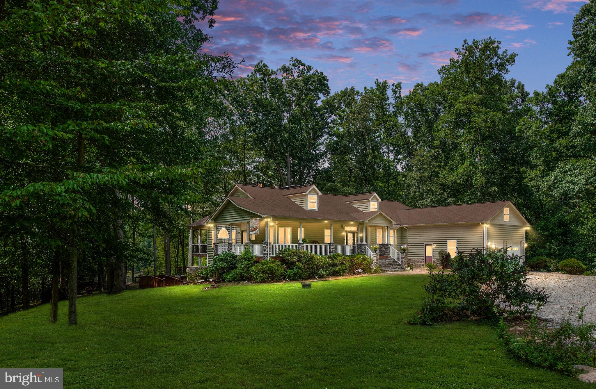 If your dream is to own a property that offers peace, play, & potential for business all-in-one, this stunning waterfront home is your winning ticket. The land & seclusion lend themselves to a bed & breakfast, mini farm, or a personal retreat unlike any other. Whether you’re seeking a permanent home, rental investment, or multi-use property, this home presents an exceptional opportunity at Lake Anna!
Unwind on Stage Coach Road as you see the Rocky’s Run stone entrance that welcomes you to your new home. Nestled away on a 6.98 ac. non-subdivision lot, the charm of this property is unlike any other. You’ll find unique sunset/moonset views, 3.5 ac. of pasture land, 3.5 ac. of matured hardwood trees, & 250’ of shoreline. This custom-built home offers 7 BR & 5.5 BA across 5,727 sq. feet with an att. 2-car garage that has attic storage space above.
Your clean, deepwater cove is calm & protected, making it great for swimming, kayaking, paddleboarding, floating the day away, or simply relaxing on your own private beach! With 12’ water depth at the dock & 22+’ deep in the cove, you can ski in & out or fish right from your dock. Location is also key - it is on the sought-after wide, public, southern end of the lake. The park-like setting provides endless outdoor entertainment possibilities – mult. decks, gazebo, 2 screened-in porches, & a large wrap-around front porch. Your dock includes a boat & jet ski lift, screened-in room w/ lighted ceiling fan, sunning deck, & storage room.
The main level features 3 BR & 3.5 BA. The flooring throughout is elegant Canadian Beech hardwood, ceramic tile, & travertine hearths at fireplaces. Stunning millwork, incl. crown molding & chair rail, are found throughout. Niches, columns, & ceiling medallions add special touches. The expansive primary suite is a true retreat – his/her walk-in closets, dual BA w/ 2 walk-in showers with a 2-seated jet spa tub, & a private library room with gorgeous built-ins & gas fireplace. It also has its own screened-in porch w/ a hot tub overlooking the lake. Two more BR & a full BA are located on the opposite end of the home w/ another screened-in porch. The family room has a beautiful hand-crafted Tiger Oak built-in, a tray ceiling, & gas fireplace with beautiful stonework. The adjacent open deck is convenient to the kitchen making entertaining relaxed & practical. You’ll also appreciate the convenience of a main level laundry room.
The heart of this home showcases a chef's kitchen w/ granite countertops, SS appliances, 5-burner Thermador gas range w/ Monogram hood, dual wall ovens w/ convection capability, & a warming drawer. The spacious layout includes a large pantry, island, breakfast bar, & attached sunroom/breakfast nook w/ stunning lake views. A separate formal dining room provides the perfect setting for elegant entertainment.
The lower level, w/ 9.5’ ceilings, features a private entrance 2-BR apt. with full kitchen, full BA, gas fireplace, & laundry area – perfect for rental income, visiting family, or an in-law suite. You'll also find a theater room wired & ready for your big screen dreams, a wet bar, & a large rec/family room with its own mini stage perfect for impromptu performances or karaoke nights. The family room also features a woodburning fireplace & propane stove for auxiliary heating. The 2 addt’l rooms & a full BA are perfect for extra guests. There's even a dedicated mud/pet room w/ a porcelain tub & its own exterior access for you & your 4-legged family members.
This isn't just a house – it's a lifestyle property offering something for everyone. Whether you're seeking a full-time lakefront residence, weekend retreat, mini farm/equestrian property, investment opportunity, or all the above, this remarkable property delivers on every level. The combination of luxury amenities, incredible lake front, with deep water, income potential, & endless recreational possibilities makes this a unique offering that rarely comes to market.