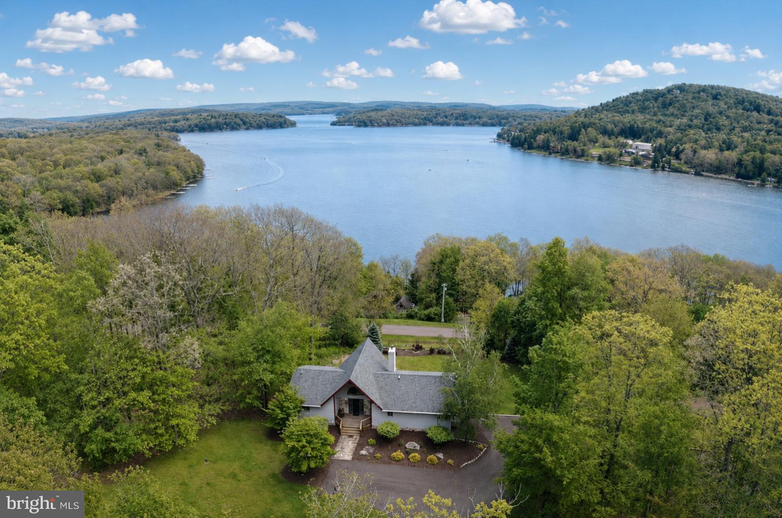 Experience mountain-lake living at its finest in this stunning 4-bedroom, 3.5-bath home boasting some of the most breathtaking views of Deep Creek Lake. Perfectly positioned to capture panoramic lake vistas, this exceptional property offers lake access and a dedicated dock slip, making it an ideal year-round retreat or vacation getaway.  Inside, you'll find numerous recent upgrades and improvements designed for both comfort and style. The main level has been thoughtfully renovated to create a more open and inviting floor plan, highlighted by beautiful new flooring and enhanced living spaces that maximize the home's incredible views. The attached garage has been completely finished and transformed into a fantastic game room and additional living area, complete with a convenient half bath, perfect for entertaining family and friends.  There is also potential for a 5th bedroom in this space.  Major updates provide peace of mind, including a new roof installed in 2023 and a newly paved driveway completed in 2025.  Whether you're relaxing on the deck overlooking the lake, spending the day on the water from your dock slip, or enjoying nearby recreational opportunities, this property truly has it all. Ideally located just minutes from Wisp Resort, area golf courses, shopping, dining, and countless outdoor activities, 119 Overlook Terrace offers the perfect combination of spectacular lake views, coveted water access, and unmatched convenience.  Don't miss this rare opportunity to own a premier Deep Creek Lake property where unforgettable memories await!