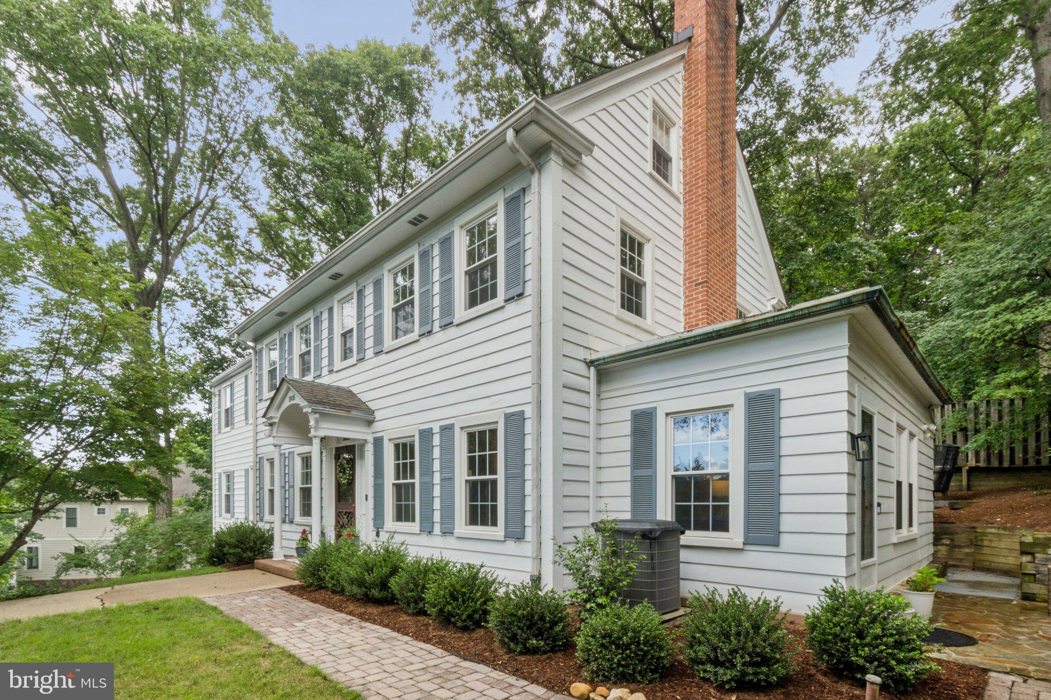 Stunning 5-bedroom colonial home situated on a 15,659sf (.36ac) lot. This generously proportioned residence features 3,810sf of finished living space across four levels. The home offers a welcoming center-hall floor plan with gleaming hardwood floors throughout the main and upper levels. Full of character, featuring arched entryways, a wood-burning fireplace with a brick hearth, and oversized windows. The large kitchen includes white cabinetry, granite countertops, and stainless-steel appliances with a double wall oven. The main level includes a formal living room, an expansive great room, a home office or bedroom, a powder room, and a full bathroom. On the upper level, you will find a luxurious owner's suite with a large sitting room, along with two additional spacious bedrooms, a shared hall bathroom and a convenient linen closet. The walk-up fourth level boasts vaulted wood-paneled ceilings which are carried throughout the large rec room and the fifth bedroom. The lower level is equipped with a wet bar, a second large rec room, a half bathroom, and laundry room. Exterior features include an attached two-car garage, a beautiful rear deck, a side patio, and mature landscaping.