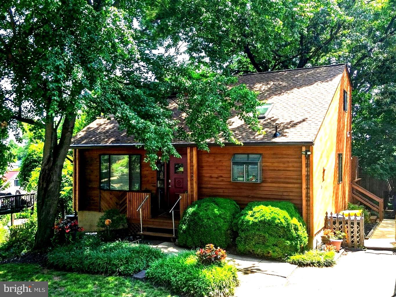YOU'LL HAVE IT MADE IN THE SHADE HERE! 
2026 UPDATES include BRAND NEW HEAT PUMP,  NEW ROOF & SKYLIGHTS W/REMOTE OPERATED MINI-BLINDS, NEW WASHER & DRYER, NEW LUXURY VINYL PLANK.   
Brand new price.  Brand new pictures.  Brand new staging.  Take a second look.
Skylights and two story living space keep the inside bright while outside you'll feel 10 degrees cooler in the shaded oasis of your lushly landscaped yard.  
Charming cedar sided chalet style set in the wooded and beach access community of Cape St Claire.
Enter into a dramatic cathedral ceiling living and dining space with skylights, looking through to a three season clerestory windowed addition where you will welcome family and friends. Sliders from the tall window surrounded sun room open onto a deck with room for feasts and relaxing.  Memories are made here. An island and deep pantry in the kitchen with a plant window for your herbs to thrive provide plenty of storage.  Generous bedroom and updated bath on the main level offer convenience and privacy.  Upstairs two bedrooms are separated by a second full bath.  Extensive landscaping with perennials lets you enjoy nature's blooms with little fuss. A fenced garden on the sunny side of the house is waiting to provide perfect tomatoes, cukes, peppers or vivid flowers for your table.  Clever tall medicine cabinet hides behind mirror on wall inside main level bath.
2026 UPDATES include BRAND NEW HEAT PUMP,  NEW ROOF W/ROMOTE OPERATED SKYLIGHTS, NEW WASHER & DRYER, NEW LUXURY VINYL PLANK.  
Replaced and stained cedar siding on one wall and trim throughout exterior. Entry porch has been refreshed as well as decking replaced on deck off sunroom  and walkway decking. Well water system just serviced. County sewer so no septic worries.