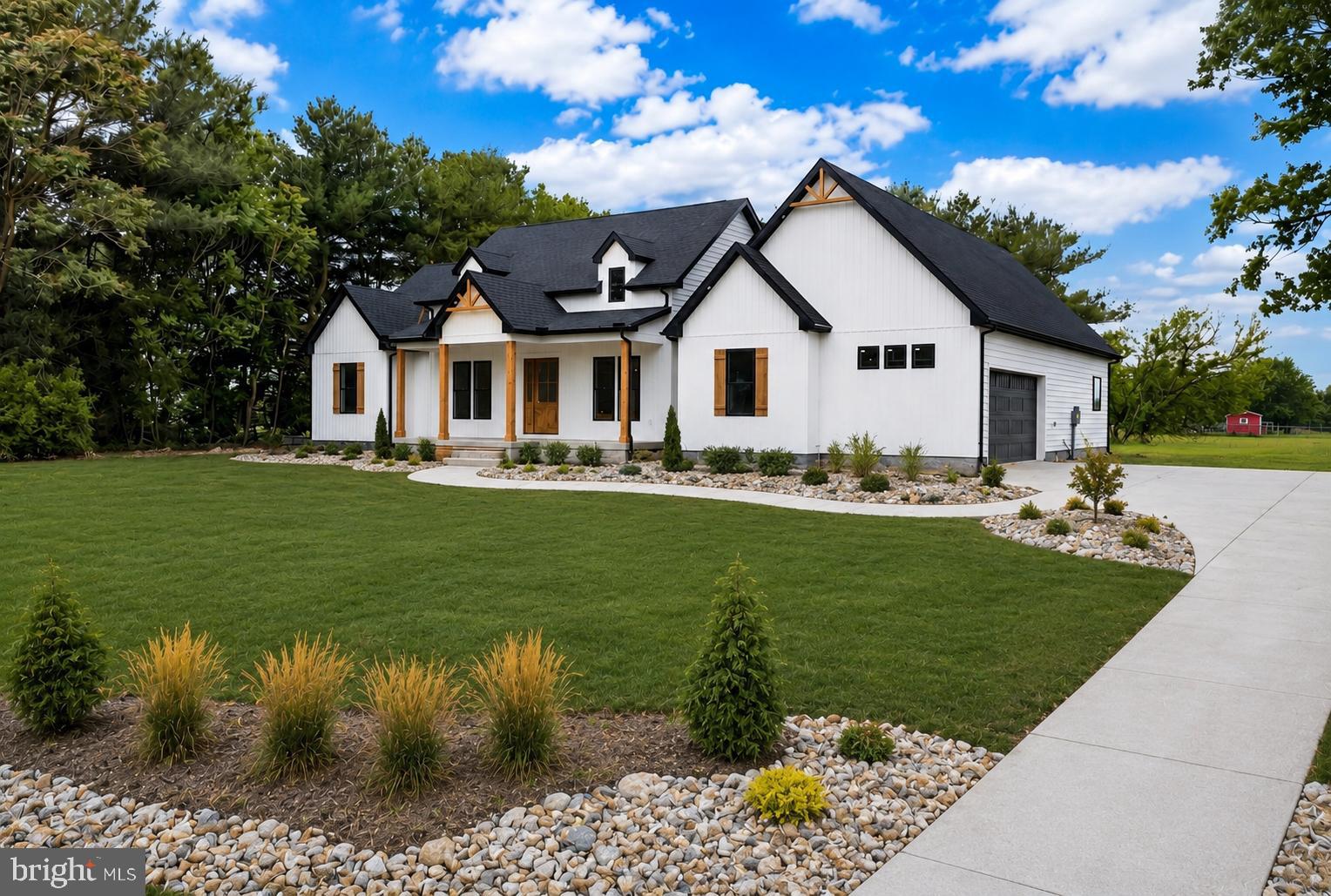 This stunning new construction home has been meticulously designed with luxury finishes, modern architecture, and every upgrade you can imagine. You are welcomed to the home with a quaint front porch. Upon entering the home, a large open floor plan greets you. The dining room is to the right of the entrance and has custom trim work.  The living room features vaulted ceilings, floor to ceiling stone fireplace, wood beams and abundant natural light. The custom kitchen is a chefs dream with stainless steel appliances, quartz countertops, tile backsplash and 42 inch cabinets. A walk in pantry is just off the kitchen as well as the wet bar, half bathroom, laundry room and access to the garage. The primary suite is a true oasis after a long day and offers an absolutely stunning custom en-suite bathroom and a substantial walk in closet.  Two additional bedrooms are also on this level with their own en-suite bathrooms and can be used for guests or another primary suite. There is also a fourth bonus room, ideal for an office or additional living space. Outside, the back porch is ideal for enjoying the warmer months and the large yard. Centrally located close to the Town of Delmar, Maryland state line and a short drive to Salisbury or the beaches. Schedule your tour today! (Please note the front exterior of the home has been digitally rendered and a driveway/sidewalk will be installed soon)