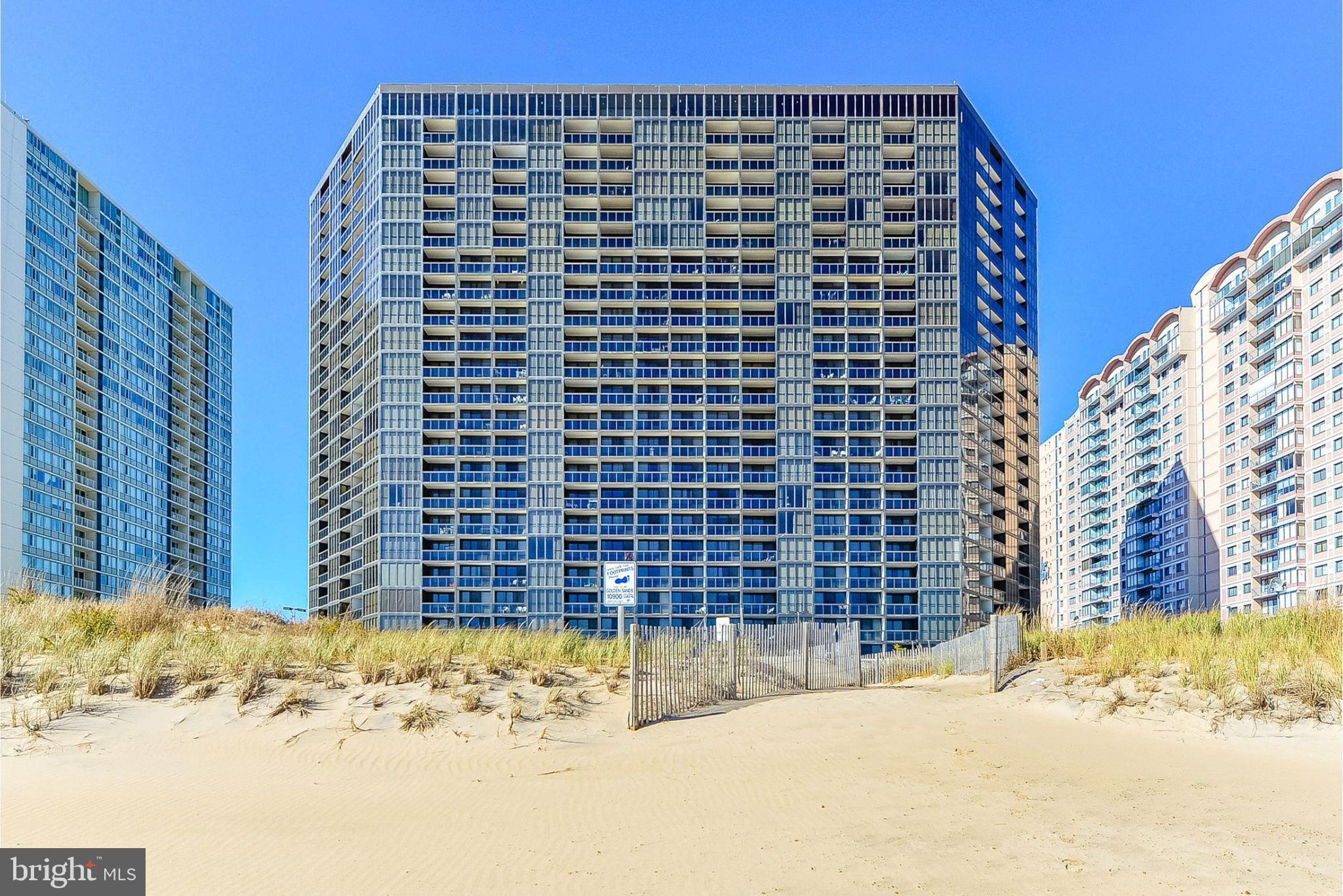 BeachLife Oceanfront... This condo is all about the view. The oceanfront primary bedroom offers floor-to-ceiling windows and direct access to the balcony, giving you a front-row seat to breathtaking sunrises over the Atlantic. With 2 bedrooms, 1.5 baths, and 825 sq. ft., the open kitchen and living room layout keeps the ocean in focus. Professional photos have been uploaded — but nothing captures the feeling of standing on your balcony with the ocean stretching out in front of you.
Golden Sands Ocean Resort... At Golden Sands, it’s all about location – North Ocean City, right on the ocean. This isn’t just another condo building… it’s a true resort experience...Endless Ways to Relax & Play
Step outside onto the massive recreation deck and you’ll find everything you need without ever leaving the building: a sparkling outdoor pool, a children’s pool, tennis and pickleball courts, shuffleboard, and even a beach volleyball court. Whether you’re up for action or just stretching out in a lounge chair, it’s all right here. Looking for more than just a summer escape? Take the elevator to the 22nd-floor penthouse level and enjoy the indoor pool, a fully equipped fitness center, and a game room. No matter the season, you’ve got year-round options to keep you moving or simply winding down... Your Own Stretch of Beach
Golden Sands is one of the few buildings in Ocean City with its own 4,000-square-foot private beachfront. It’s your chance to enjoy the ocean at your own pace, without the crowds... Food, Drinks & Convenience Just Steps Away... Why leave when you’ve got it all on site? The deck serves up a Tiki Bar and Grill for casual meals, an ice cream parlor, a deli, and even a beach shop for the essentials. Oceanfront living doesn’t get easier than this. Peace of Mind, 24/7... With round-the-clock security and maintenance staff, you can relax knowing everything is taken care of — so you can focus on what matters most: life by the water. Prime Location in Ocean City... Golden Sands puts you in the center of it all. Walk to local favorites like The Greene Turtle and Bull on the Beach, or take a short drive to the iconic Ocean City Boardwalk with its shops, amusement parks, and nonstop entertainment.