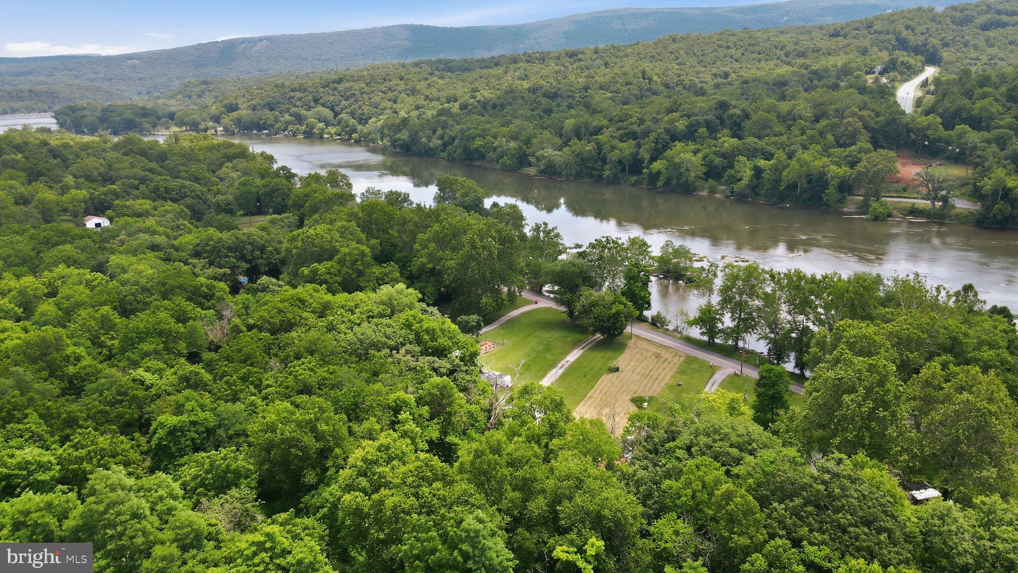 Act fast for this UNRESTRICTED, CLEARED residential lot on the SHENANDOAH RIVER! The seller has septic, well, and driveway PERMITS in hand, and now his change of plans could be your riverfront dream! The half-acre lot has 46 feet of waterfront for your kayaking, fishing, and nature-watching enjoyment. Take an easy float downriver to public boat launches and picnic areas at Moulton Park and Big Eddy. If new home construction is your goal, higher ground at the back of the lot provides a potential site above the flood plain, and the approved perc supports a 2BR septic design. Or, simply park your camper or set up your tent and start your vacation lifestyle today! Charles Town center is 2 miles away with trendy restaurants, charming shops, Hollywood Casino and horse racing. Nearby attractions are the Appalachian Trail, historic sites from George Washington’s heritage and the Civil War, and craft breweries and vineyards. All this, plus easy access to northern VA and DC.