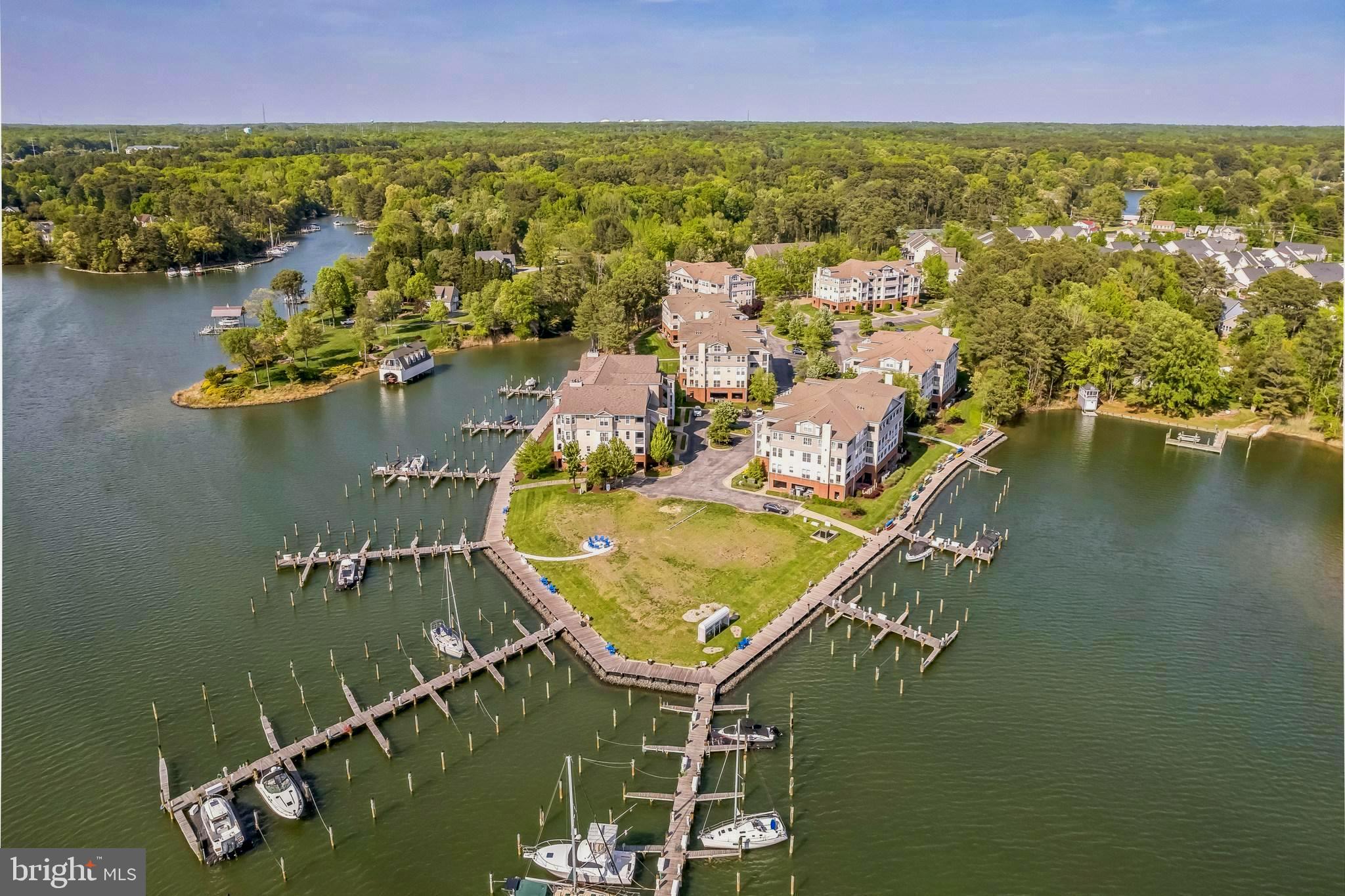 The Solomons waterfront lifestyle is at its best with stunning 180 degree water views from this end corner unit and resort style community amenities. The unit is beautifully appointed with upgrades throughout and an open concept main living area. Enjoy spectacular sunsets and gorgeous water views from the private balcony. There is also additional storage on the balcony, unique to this building, as well as storage in the covered parking area, and ample overflow parking for guests. In addition, the HVAC was replaced in 2023. The building features an elevator for convenience, in addition to stairs. Boaters will love the immediate access to the Chesapeake Bay and Patuxent River, with boat slip(#9) on the F pier easily navigable from Back Creek. Charming Solomons and area conveniences are nearby, with many restaurants, shops, museums, art center, athletic fields, historical interests and more. The perfect waterfront lifestyle can be found here in Oyster Bay – a great weekend getaway, or wonderful place to make a full time home.