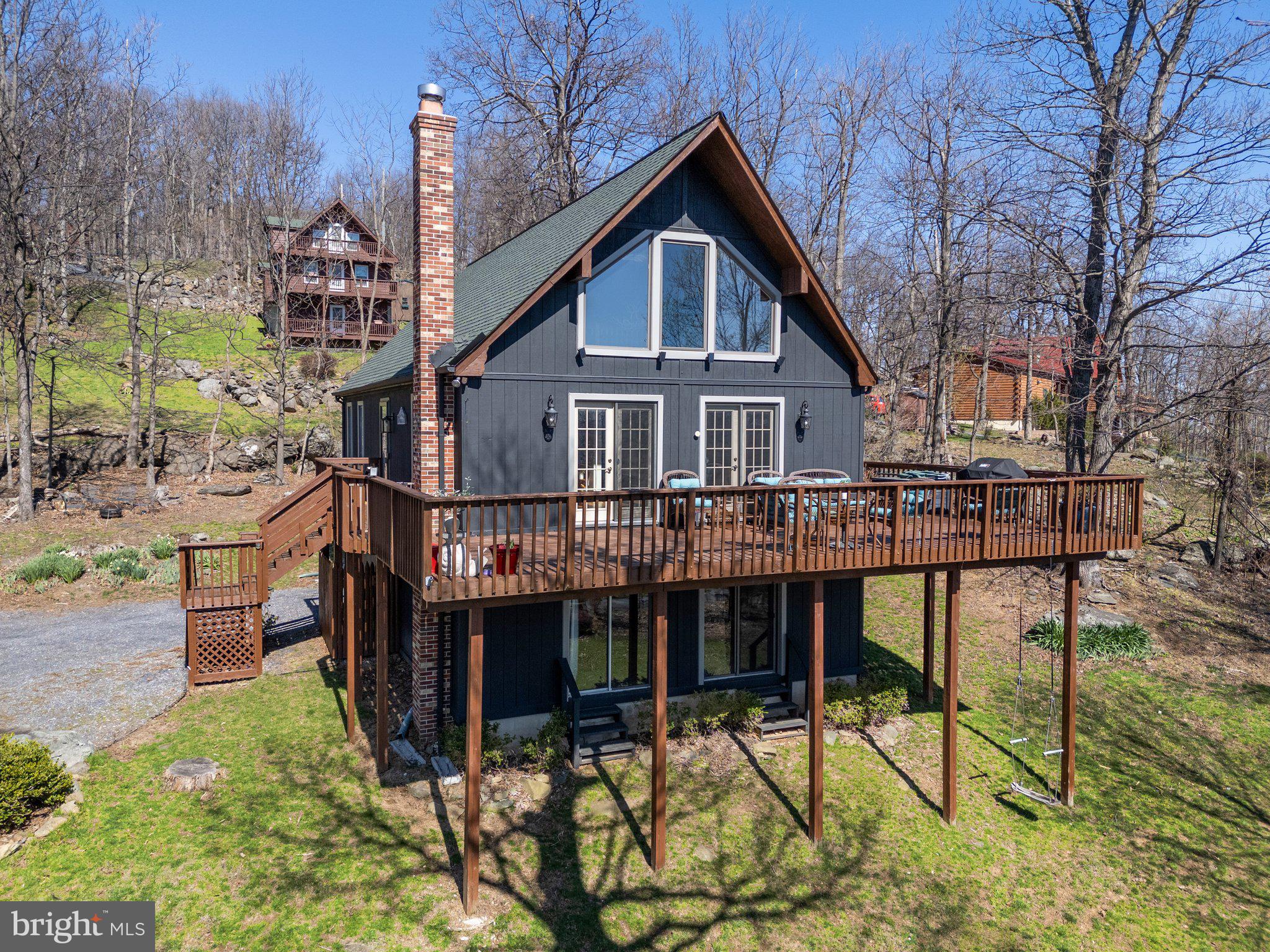 Welcome to your mountain retreat! Nestled in the heart of nature, this beautifully maintained 3-bedroom, 2-bath chalet offers stunning panoramic views of the Blue Ridge Mountains and a peaceful escape just minutes from adventure.

Located in scenic Front Royal—known as the “Gateway to Shenandoah National Park”—this home is perfectly positioned for outdoor enthusiasts. Enjoy quick access to the Appalachian Trail, Shenandoah River, and the park’s countless hiking, kayaking, and wildlife-watching opportunities.

Inside, the open-concept living area features soaring vaulted ceilings, a cozy wood stove, and large windows that flood the space with natural light and frame exceptional mountain vistas. It is perfect for weekend getaways or full-time living. Step out onto the spacious deck—ideal for morning coffee, sunset views, or stargazing under clear country skies.