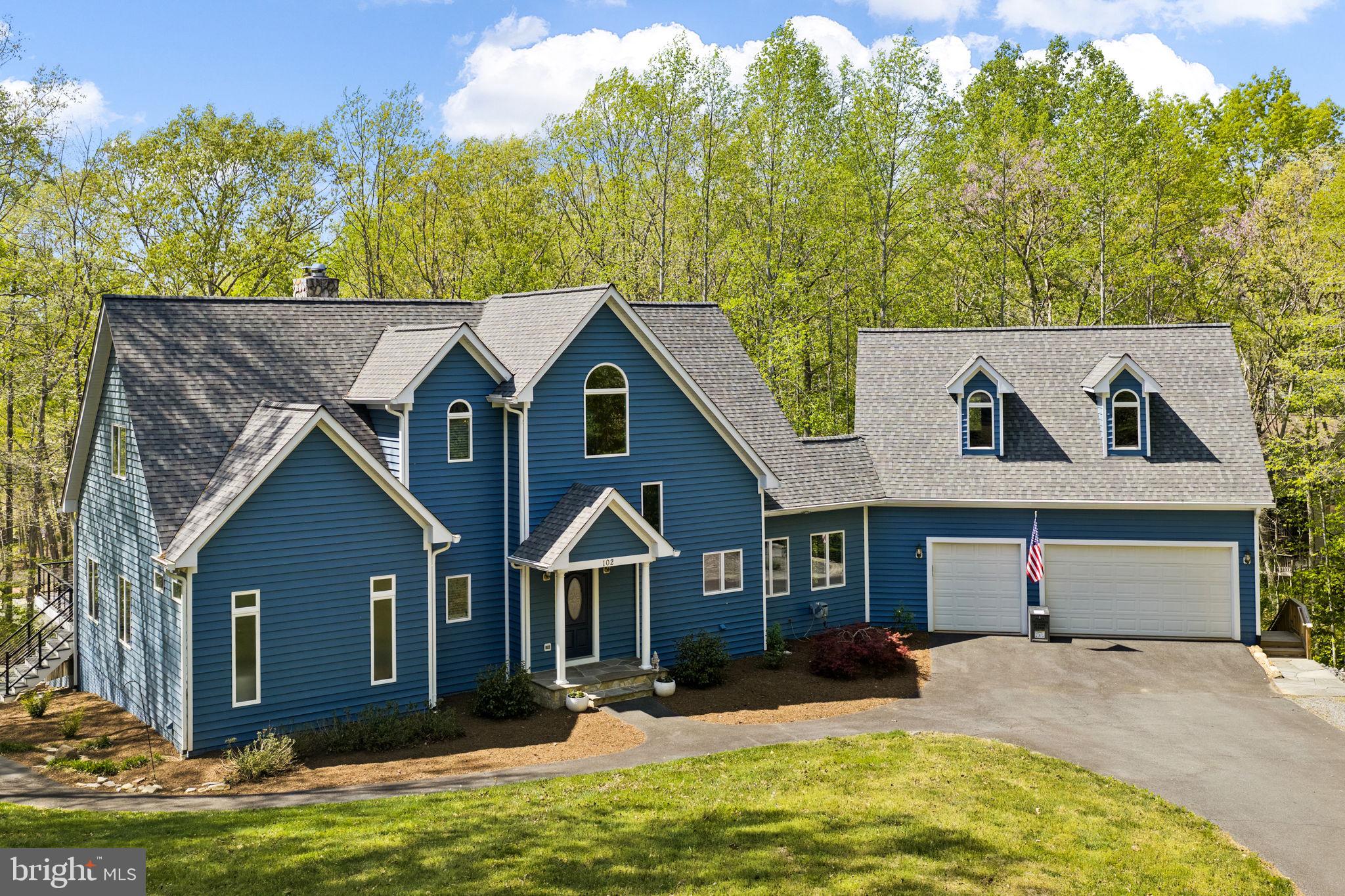 Perfectly set on a very private one-acre parcel at Lake Anna, this recently upgraded waterfront masterpiece truly captures the essence of lakefront living on the public side of the lake, offering a prime mid-lake location in Lakeshore Woods, with over 100 feet of shoreline, a large two-slip boathouse, complete with sun deck and convenient storage room.  Thoughtfully designed for both relaxation and recreation, this completely furnished property invites you into effortless days on the water and peaceful evenings surrounded by nature, with a level of privacy that is increasingly hard to find.  Offered furnished and turnkey—including a golf cart—this home is ready to be enjoyed from day one, whether as a personal escape or a high-performing short-term rental investment. Inside, over 5,000 square feet of thoughtfully designed living space is anchored around a dramatic great room, featuring soaring vaulted ceilings and a wall of windows framing dramatic views of Lake Anna and nature. The renovated kitchen is both upscale and functional, appointed with stainless steel appliances, granite and soapstone countertops, a large gas cooktop with hood, backsplash and fireback, and a generous island designed for gathering. The main level primary suite offers a true sense of comfort with direct deck access, a spa-inspired luxurious bathroom with heated tile floors, a designer tile shower (also with heated floors), standalone soaking tub, double floating vanities, and an oversized walk-in closet with custom California Closet system.  The upper level features two additional large guest bedrooms and a full bathroom.  The finished basement includes a large recreation area  - complete with pool table, foosball table, and double-sided fireplace with mantle - along with three additional spacious bedrooms, and another full bathroom.  The outdoor living space is equally inviting, with an expansive deck overlooking the lake, enhanced by new modern cable railing, a beautifully designed hardscape with fire pit for evenings under the stars, and a large two-slip boathouse with recently-service electric boat lifts and a sun deck.   With high-speed fiber internet, an oversized attached garage with unfinished space above for storage or future expansion, and strong rental / investment potential, this waterfront property delivers a rare and powerful combination of comfort, versatility, and lakefront living.  Recent upgrades include a new roof (2024), new HVAC systems (2025 and 2022), and new exterior painting (2024)(see documents section for a complete list of renovations and upgrades recently performed by the sellers).  Location is ideal: five minutes from groceries, local restaurants, The Lake Anna Taphouse, Coffee & Creamery, ABC, vet clinic, nail salon, and more.  Less than 45 minutes to Richmond, Charlottesville, and Fredericksburg, and just 82 miles to our nation's capital, Washington DC.  Investors: short term rentals are permitted here, and this turnkey property is ready to print money.