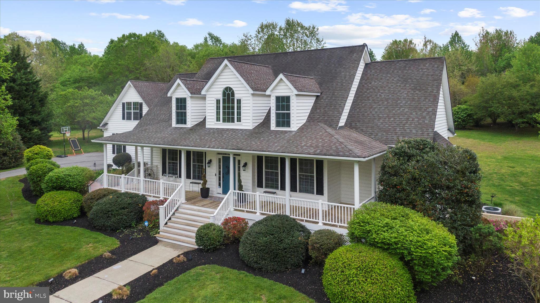 Back on market—prior contract fell through due to buyer financing.

Experience the Best of Country Living at 21 Owensville Road

Welcome to 21 Owensville Road, a stunning custom-built Chaney home set on 3+ beautifully landscaped acres in the heart of Southern Anne Arundel County. Surrounded by rolling farmland and just minutes from the boating paradise of the West River, this exceptional property offers peaceful country living with easy access to Annapolis, Washington, DC, and Baltimore.

Thoughtfully updated by the Design & Installation Group, this three-story residence offers over 6,000 square feet of refined living space, including a fully finished lower level and a private studio above the garage. From the moment you arrive, mature trees, scenic views, and inviting hardscaped walkways set the tone for the serene lifestyle that awaits.

The sun-filled main level features soaring two-story ceilings and an open floor plan designed for modern living and entertaining. French doors open to expansive front and rear porches, creating a seamless connection between indoor and outdoor spaces—perfect for relaxing or dining while taking in the surrounding natural beauty.

At the heart of the home, the spacious kitchen is an entertainer’s dream with a large center island, generous countertops, cooktop, wall oven, and a bright breakfast area. The main level also includes a recently renovated primary suite with French doors to the back porch, a spa-inspired bathroom with soaking tub, double vanity, and a large walk-in closet. A second main-level bedroom with a private, updated ensuite bath provides additional flexibility and convenience.

Additional main-level highlights include an updated mud and laundry room with custom built-ins, a powder room, a formal dining room ideal for hosting, and a cozy living room centered around a gas fireplace with custom built-in bookshelves.

Upstairs, three generously sized bedrooms share a full bath, complementing the two ensuite bedrooms on the main level. The fully finished lower level offers even more space to live and entertain, featuring a family room, gym, game room, wet bar, full bath, and private walk-out access—ideal for guests or multigenerational living.

The two-car garage provides ample storage and workspace, while the fully finished studio above offers the perfect setting for a home office, creative studio, or guest accommodations.

Outside, the property’s natural beauty continues with a tucked-away gazebo for quiet moments, a large shed for outdoor equipment, and meticulously maintained gardens showcasing vibrant seasonal foliage.

Life in Harwood offers the best of Maryland’s countryside lifestyle—boating, fishing, and waterfront exploration just minutes away—while remaining close to the cultural, dining, and entertainment amenities of Annapolis, DC, and Baltimore.

If you’re searching for a rare blend of serene country living, water access, and city convenience, 21 Owensville Road is truly something special.
Schedule your private tour today.