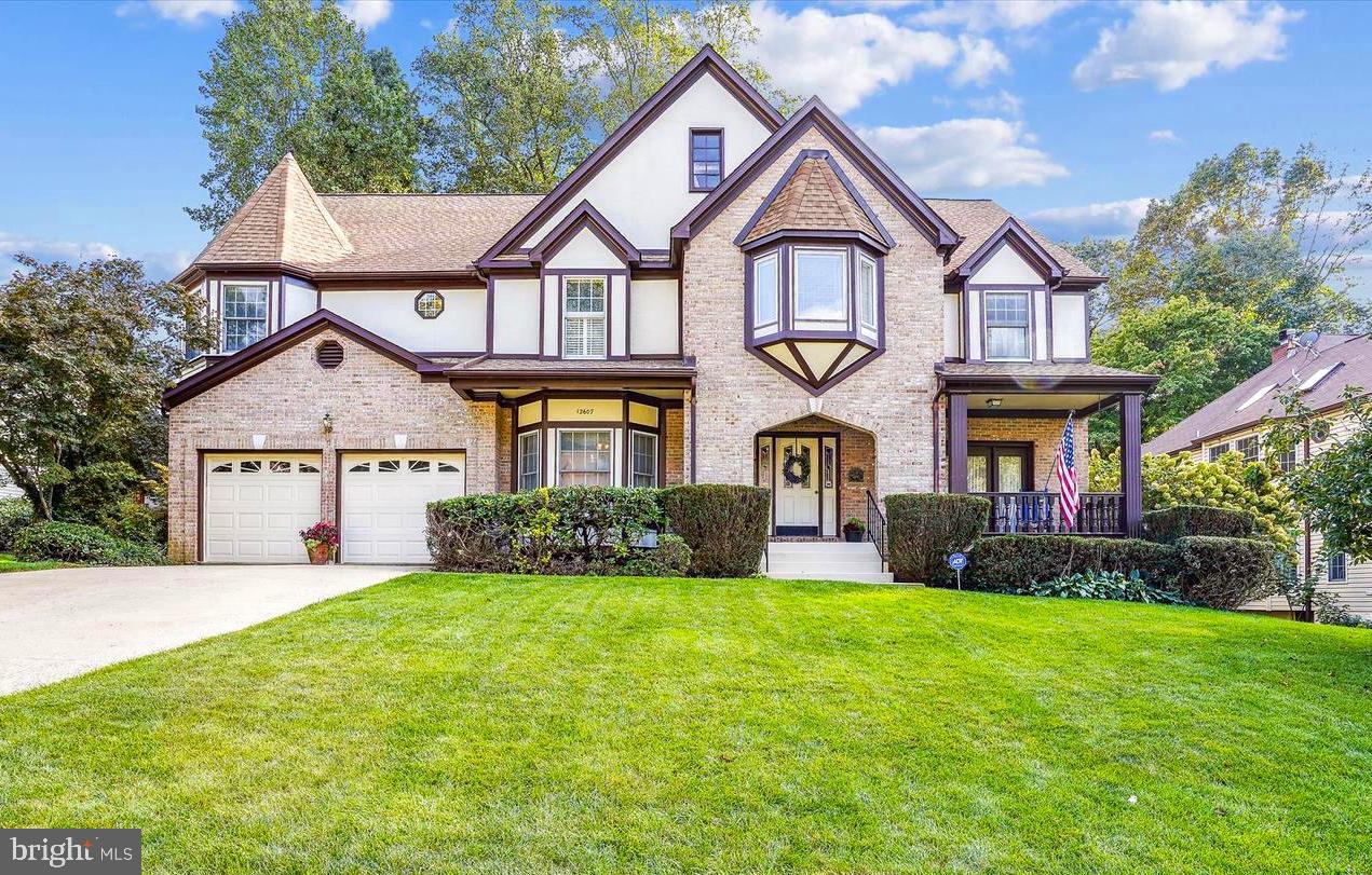 A rare Grand Barrington Tudor in the sought-after Hampton Chase section of Hampton Forest. This brick-and-stucco home offers 5,409 sq ft of living space with a welcoming front porch and sits on a quiet street with a large deck and fenced yard. Recent upgrades include brand-new, high-quality hardwood floors throughout the main and upper levels, fresh modern interior paint, and stylish new lighting with elegant chandeliers. The gourmet eat-in kitchen features quartz counters, a large island, gas cooktop, wall ovens, and newly upgraded stainless steel appliances. The open-concept main level flows beautifully creating an airy, inviting space. A private office has been fully renovated and modernized for today’s work-from-home needs. The two-story family room with brick fireplace opens to the deck—perfect for entertaining. Upstairs, the spacious primary suite includes a sitting area, large walk-in closet, cedar closet, and spa-like bath with double sinks, soaking tub, and separate shower. Three additional bedrooms share updated baths. The finished lower level offers a fifth bedroom with egress, full bath, wet bar, and flexible space for a theater, gym, or recreation area. Smart home features include a Nest thermostat and SimpliSafe alarm system. Excellent commuter location with easy access to major routes, plus top-rated Fairfax County schools.