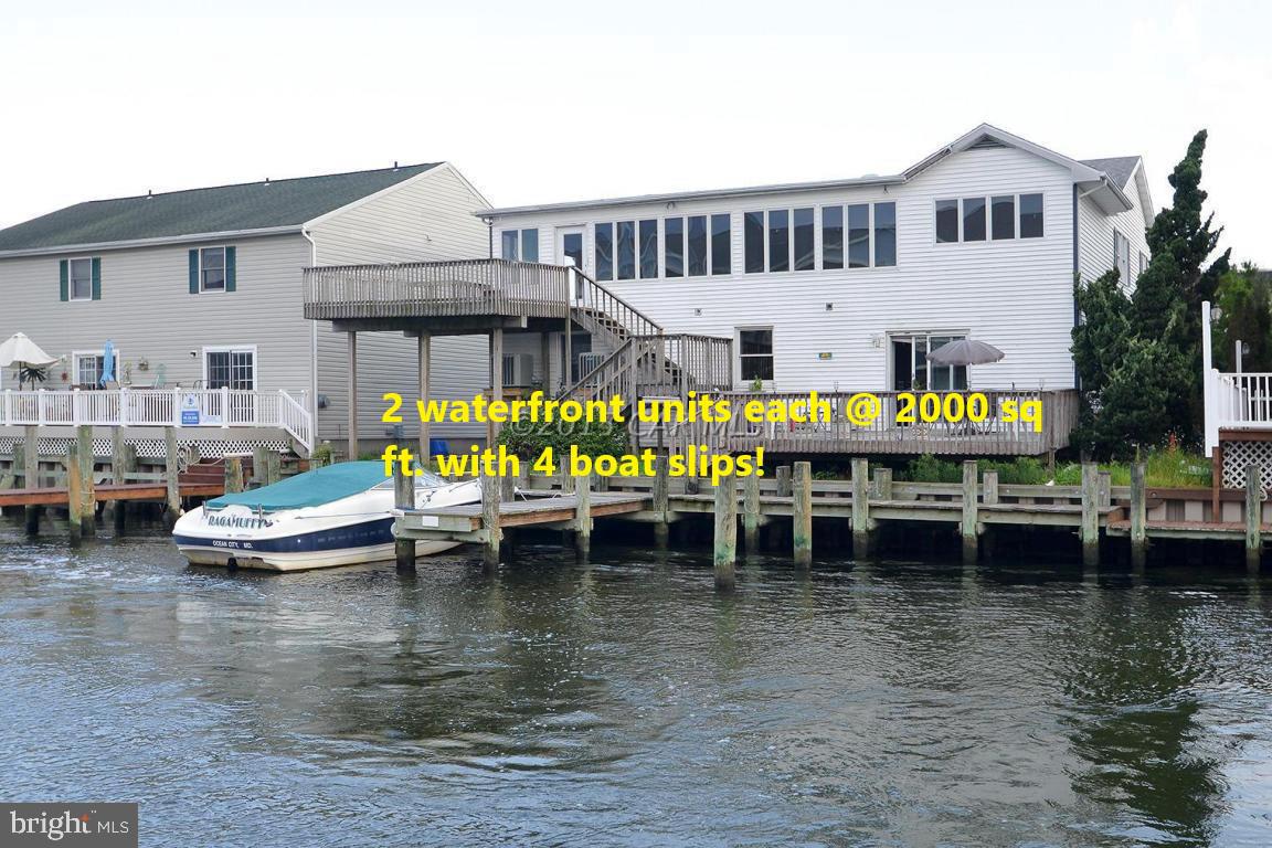 Unique waterfront property.  2 huge 2000 sq. ft. +- canal front units. Each offers large decks overlooking the wide canal and dock area.  Multiple boat slips with room for 4 boats.  1st floor unit is 2000 sq. ft. +- and features 3 bedrooms (2 w/master suites) and 3.5 baths.  Spacious open concept (kitchen, living room, dining room).  Upstairs unit is 2000 sq. ft. +-  with 3 bedrooms/2 bath plus office and a 35X14 sunroom with a wall of windows overlooking the canal.  An oversized kitchen & huge deck.  Great opportunity to live in one and rent the other, rent both units year round or better yet as a short term summer vacation rental for maximum income potential.  Great for 2 families or large family.   NO CONDO FEES.
