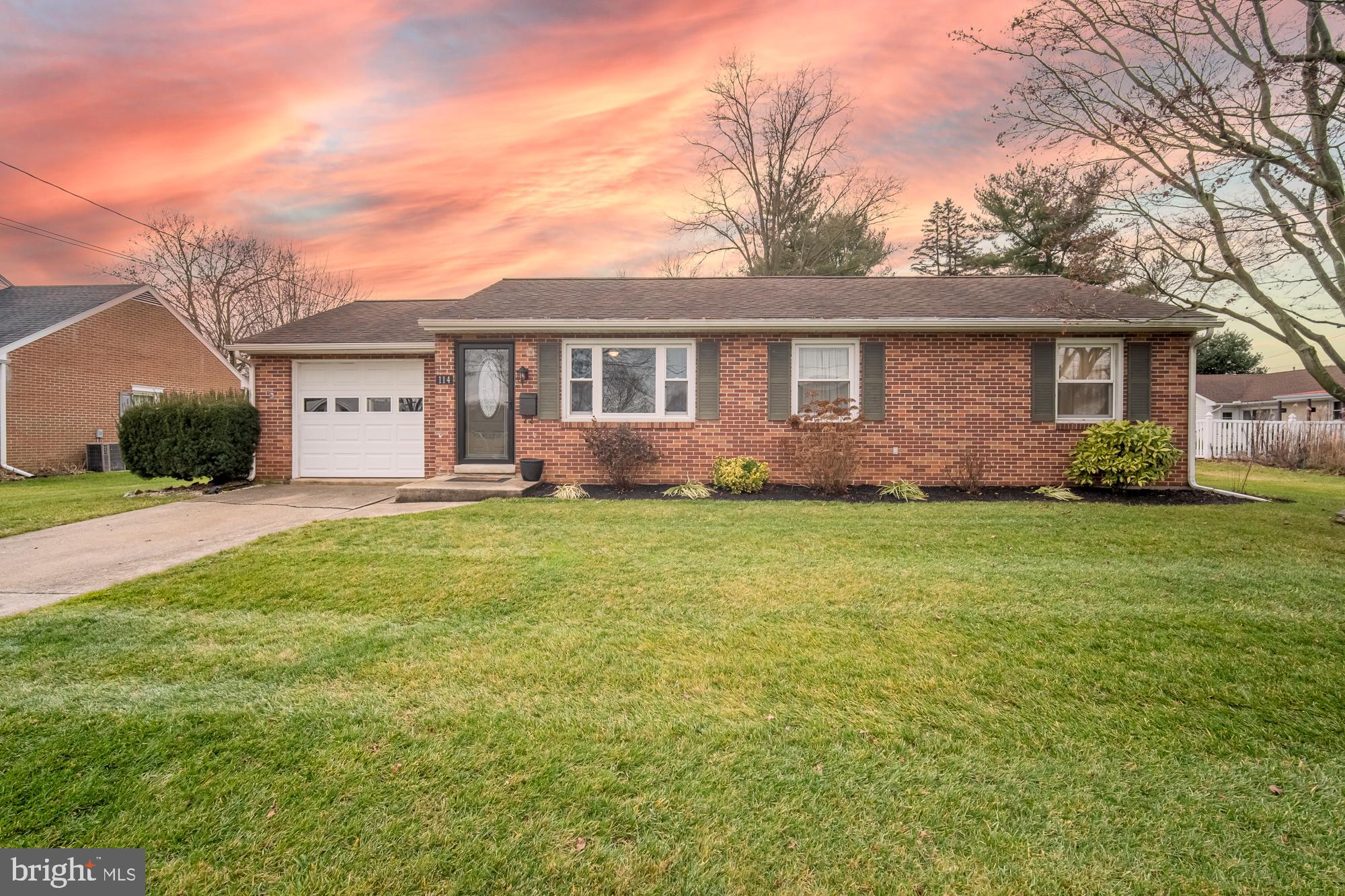 The traditional three bedroom brick rancher in suburbia! This is 114 Emig Street in the Brigadoon neighborhood of Hallam Boro...  Whether you are downsizing or just starting out this simple home is a must consider!  And if you need extra living space or would like a space to entertain friends for the big game, you’ll be glad to know that this home has a recently finished basement offering a large open space.  Utilize a corner of the room for an at-home office or playroom or for whatever might serve your household’s needs.
Behind the home is a covered patio so you can spread out your living space in the warmer months. Enjoy a relaxing lounge reading a book or sipping a beverage with relative privacy offered by mature trees and placement of neighboring homes.  Or use this space to dine outside after a summer grill.  The yard is ample for play or for a garden for those with a green thumb.
The Brigadoon neighborhood offers the suburban lifestyle where one might enjoy a stroll around the neighborhood, hanging out with neighborly friends, and close proximity to many in-town amenities such as Jim & Nena’s Pizzeria for a great spot to grab quick dinner, Hallamshire for a place to meet friends, or the many parks and recreational fields in town– in fact the softball and baseball fields are just a stone’s throw away!  Emig Park offers acres of enjoyment with playgrounds, athletic courts, creek play, and a walking trail so that there’s something for everyone in the family.  Greater amenities in East York are just 10 minutes away to offer plenty of options for shopping, restaurants, and more!  So if you would love a brick rancher in a great suburban neighborhood like this one, schedule your private showing today!