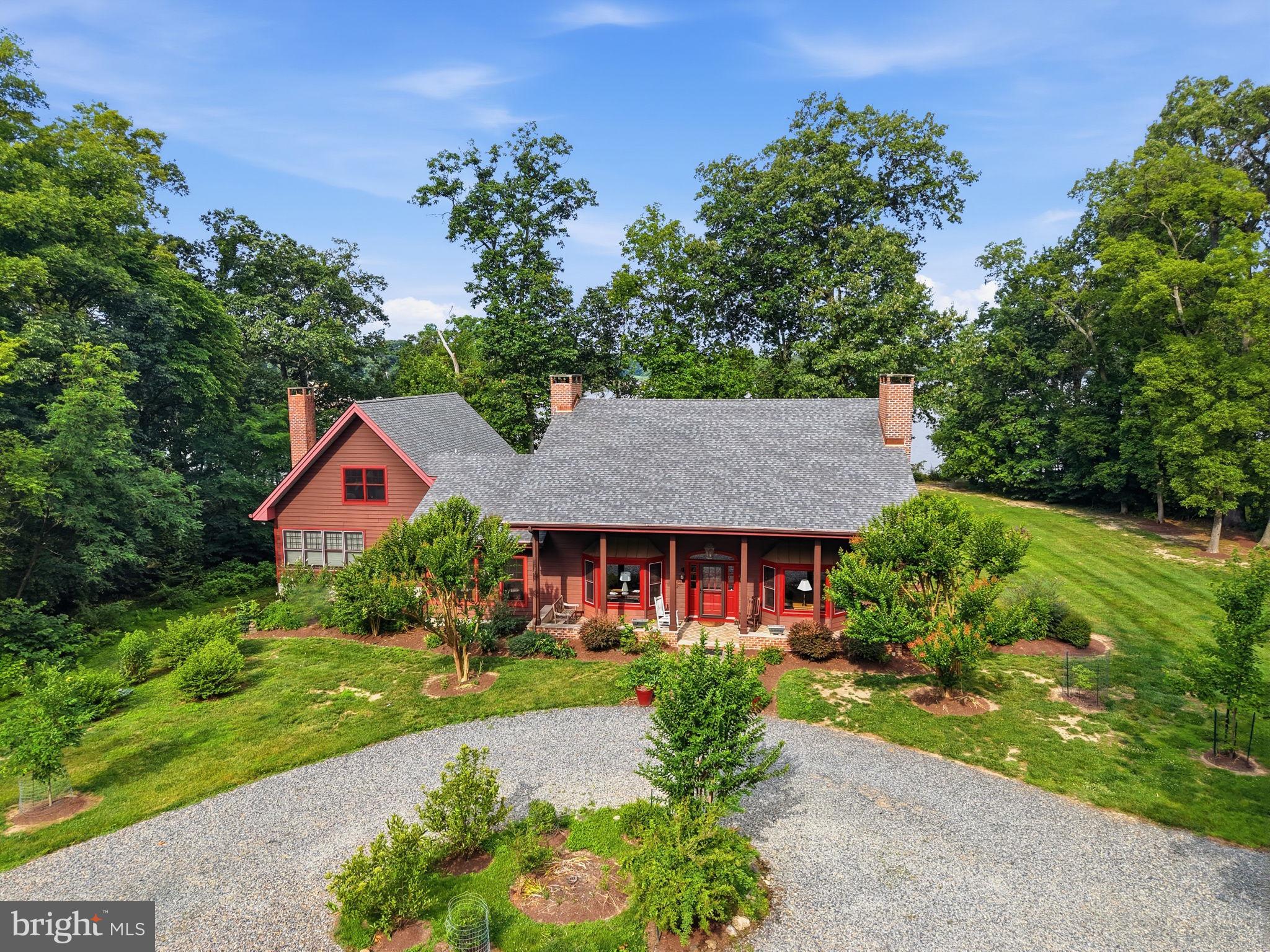 Welcome to 22470 Fairgale Farm Ln, a spacious home and property perched over Fairlee Creek, with an assigned boat slip.  3.55 acres, partly wooded, exceptionally landscaped, and perfectly framed water views. Walk down to the water to enjoy the views or launch a kayak.  The deep-water boat slip, outfitted with a boat lift, is just a short distance away.
The home features 4 bedrooms and 5 full bathrooms, plus a large loft that could be used as an additional bedroom. The large eat-in kitchen has expansive windows that perfectly frame the water view. A great spot for entertaining! Doors in the kitchen lead to the waterfront deck, spanning the front of the home. 
In both sitting rooms, you’ll find fireplaces that have been conveniently updated to propane. The first-floor primary bedroom opens up to the waterfront deck and offers a fantastic water view, as well as a large bathroom that was recently updated. 
Upstairs you’ll find two waterfront bedrooms, one with an updated attached bath. There's a second full bathroom and ample closet space in the hallway. 
Downstairs, there are two additional full bathrooms and a large bedroom. Above the kitchen sits the light-filled loft, a great office, studio, or extra bedroom. 
The exterior has a generous front porch, outdoor shower, circular drive, 2-car garage, fenced dog run, and additional garage space connected to the basement. 
This light-filled waterfront property is located 15 minutes away from the waterfront community of Rock Hall and historic Chestertown.