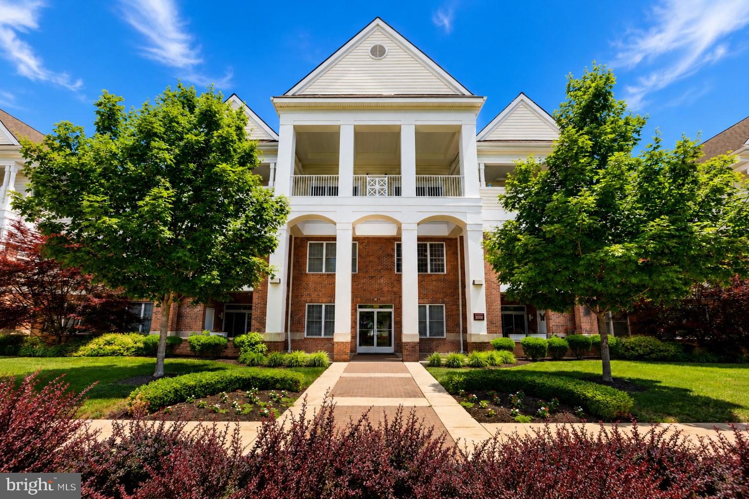 Enjoy luxury-style living at the highly sought-after Meridian at Valley Square, one of Bucks County’s premier active adult communities. This beautifully maintained residence offers an impressive 2,074 square feet of thoughtfully designed living space, blending elegance, comfort, and convenience. Enter through the welcoming foyer featuring an oversized closet and step into the beautiful open-concept living area. Throughout the home, you'll find tasteful fixtures, recessed lighting, decorative trim work, and 9-foot ceilings that enhance the spacious feel. The heart of the home is the expansive main living area, highlighted by gorgeous hardwood flooring and an open layout ideal for both everyday living and entertaining. The kitchen features 42-inch cabinetry, granite countertops, stainless steel appliances, a tasteful tile backsplash, and a two-tier center island with seating. Adjacent to the kitchen is a breakfast area for casual dining and morning coffee. A formal dining area gracefully separates the kitchen and living room, providing the perfect setting for a dining table and hutch with built-in dry bar. The spacious living room offers ample room for larger furnishings, a cozy electric fireplace, and sliding glass doors leading to a private balcony, a great space for relaxing or entertaining outdoors. The generously sized primary suite serves as a comfortable retreat with abundant closet space and a well-appointed bath featuring tile flooring, stall shower and separate vanities. A second bedroom provides excellent accommodations for guests while also offering flexibility for a home office. A full hall bath with a tasteful vanity and tub/shower combination adds additional convenience. Completing the interior is a convenient laundry closet and ample storage throughout. Additional storage is found in the storage room, perfect for seasonal items and household belongings. The home also includes a deep garage equipped with built-in shelving and a garage door opener, providing plenty of space for parking, storage, and organization. Residents enjoy the added security of a controlled-access building entrance and the convenience of elevator access. Residents enjoy a low-maintenance lifestyle with access to exceptional community amenities, including a clubhouse, fitness center, outdoor pool, walking paths, and beautifully landscaped grounds. Conveniently located just steps from shopping, dining, and everyday conveniences, this home offers the perfect blend of luxury-style living and low-maintenance ownership in an exceptional location.