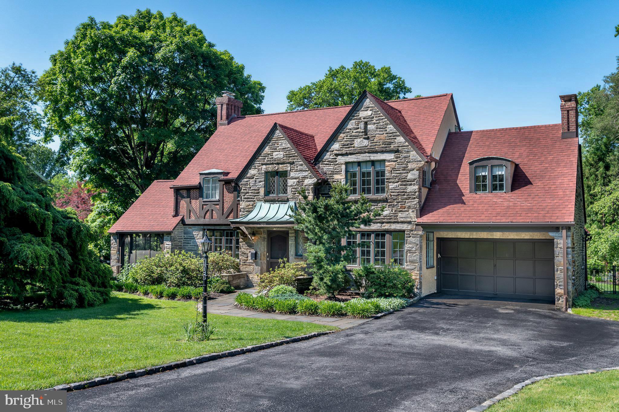 Welcome to 105 Stratford Road, a striking stone Tudor in the desirable enclave of Wallingford Hills. Quick settlement is possible - move in before school starts. Driving in feels wonderfully removed from the pace of everyday life, with timeless homes, mature landscaping, and flowering trees creating the atmosphere of a quaint storybook village. The home exudes the craftsmanship and enduring quality of a bygone era. With its handsome stone masonry, intricate patterned brickwork, decorative half-timbering and steel-casement windows, this Tudor residence offers extraordinary character and architectural authenticity. It offers over 3,700 square feet of total living space and features 4 bedrooms with 2 full baths / 3 half baths, and a partially finished basement.

Inside, numerous windows fill the home with natural light. The expansive living room centers around a lovely fireplace and flows seamlessly to a screened porch, creating an inviting space for both entertaining and everyday living. The gracious dining room comfortably accommodates large gatherings with ease. The updated kitchen features granite countertops, premium stainless steel appliances, and an oversized Dacor range. Just beyond, a mudroom connects directly to the garage and basement storage area. At the end of the center hall, an intimate den provides the perfect retreat for relaxing mornings/evenings, and allows access to the fenced back yard.

The second floor offers an ideal balance of charm and practicality with four spacious bedrooms, two full baths, a half bath, and laundry area, The primary suite is both elegant and comfortable, complete with a dressing area and en suite bath. A vaulted guest bedroom features a private half bath with stackable washer/dryer. Two additional generously sized bedrooms share a hall bath. A walk-up attic provides easy access for storage.

The finished lower level expands the home’s living space with another impressive stone fireplace, wet bar, powder room, full laundry area, office alcove, and abundant storage — ideal for movie nights, game days, or hosting guests.

Outside, the grounds are equally captivating. Distinctive plantings and specimen trees frame the property beautifully. Lush greenery provides ample privacy for relaxation. The expansive and fully fenced two-tiered rear lawn offers exceptional versatility, equally suited for play, pets, or elegant outdoor entertaining.

Recent valuable upgrades include: new roof & gutters (2024), backyard fencing (2024), addition of central air conditioning on the main level (2024), and a new sewer lateral (2023).

Ideally located within the award-winning Wallingford-Swarthmore School District, the home is within walking distance to the train station and just minutes from the shops and restaurants of Media, major roadways, and Philadelphia International Airport.

Wallingford Hills is more than a neighborhood — it is a true community. Residents enjoy long standing traditions including block parties, Oktoberfest celebrations, and holiday get-togethers - all contributing to the warm and connected atmosphere that makes it so special. Opportunities to own a home of this character, scale, and provenance in Wallingford Hills are exceedingly rare. Don’t miss your chance to be a part of this very special community.