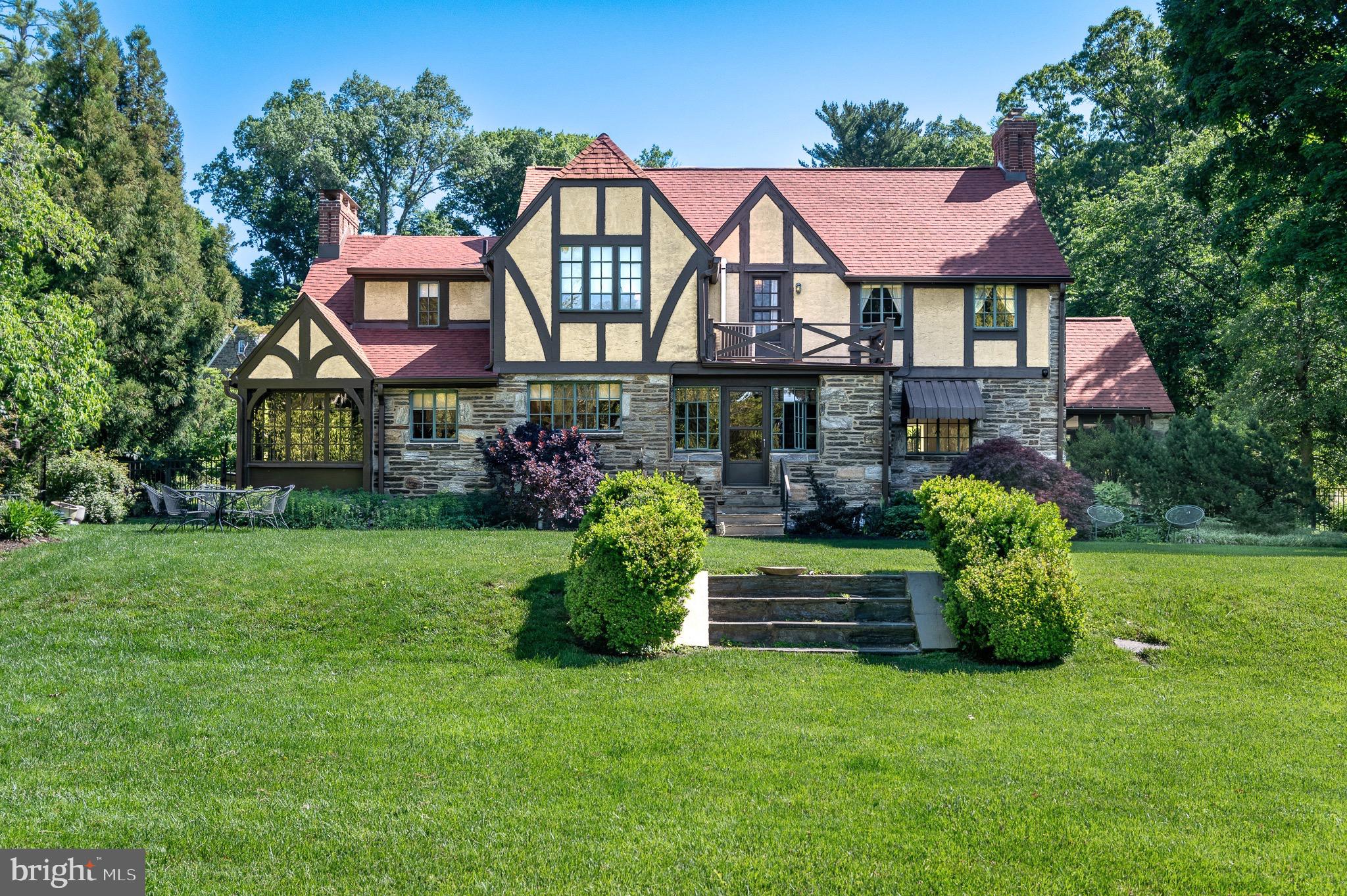 Welcome to 105 Stratford Road, a striking stone Tudor in the desirable enclave of Wallingford Hills. Driving in feels wonderfully removed from the pace of everyday life, with timeless homes, mature landscaping, and flowering trees creating the atmosphere of a quaint storybook village. The home exudes the craftsmanship and enduring quality of a bygone era. With its handsome stone masonry, intricate patterned brickwork, decorative half-timbering and steel-casement windows, this Tudor residence offers extraordinary character and architectural authenticity. It offers over 3,700 square feet of total living space and features 4 bedrooms with 2 full baths / 3 half baths, and a partially finished basement.

Inside, numerous windows fill the home with natural light. The expansive living room centers around a lovely fireplace and flows seamlessly to a screened porch, creating an inviting space for both entertaining and everyday living. The gracious dining room comfortably accommodates large gatherings with ease. The updated kitchen features granite countertops, premium stainless steel appliances, and an oversized Dacor range. Just beyond, a mudroom connects directly to the garage and basement storage area. At the end of the center hall, an intimate den provides the perfect retreat for relaxing mornings/evenings, and allows access to the fenced back yard.

The second floor offers an ideal balance of charm and practicality with four spacious bedrooms, two full baths, a half bath, and laundry area, The primary suite is both elegant and comfortable, complete with a dressing area and en suite bath. A vaulted guest bedroom features a private half bath with stackable washer/dryer. Two additional generously sized bedrooms share a hall bath. A walk-up attic provides easy access for storage.

The finished lower level expands the home’s living space with another impressive stone fireplace, wet bar, powder room, full laundry area, office alcove, and abundant storage — ideal for movie nights, game days, or hosting guests.

Outside, the grounds are equally captivating. Distinctive plantings and specimen trees frame the property beautifully. Lush greenery provides ample privacy for relaxation. The expansive and fully fenced two-tiered rear lawn offers exceptional versatility, equally suited for play, pets, or elegant outdoor entertaining.

Recent valuable upgrades include: new roof & gutters (2024), backyard fencing (2024), addition of central air conditioning on the main level (2024), and a new sewer lateral (2023).

Ideally located within the award-winning Wallingford-Swarthmore School District, the home is within walking distance to the train station and just minutes from the shops and restaurants of Media, major roadways, and Philadelphia International Airport.

Wallingford Hills is more than a neighborhood — it is a true community. Residents enjoy long standing traditions including block parties, Oktoberfest celebrations, and holiday get-togethers - all contributing to the warm and connected atmosphere that makes it so special. Opportunities to own a home of this character, scale, and provenance in Wallingford Hills are exceedingly rare. Don’t miss your chance to be a part of this very special community.
