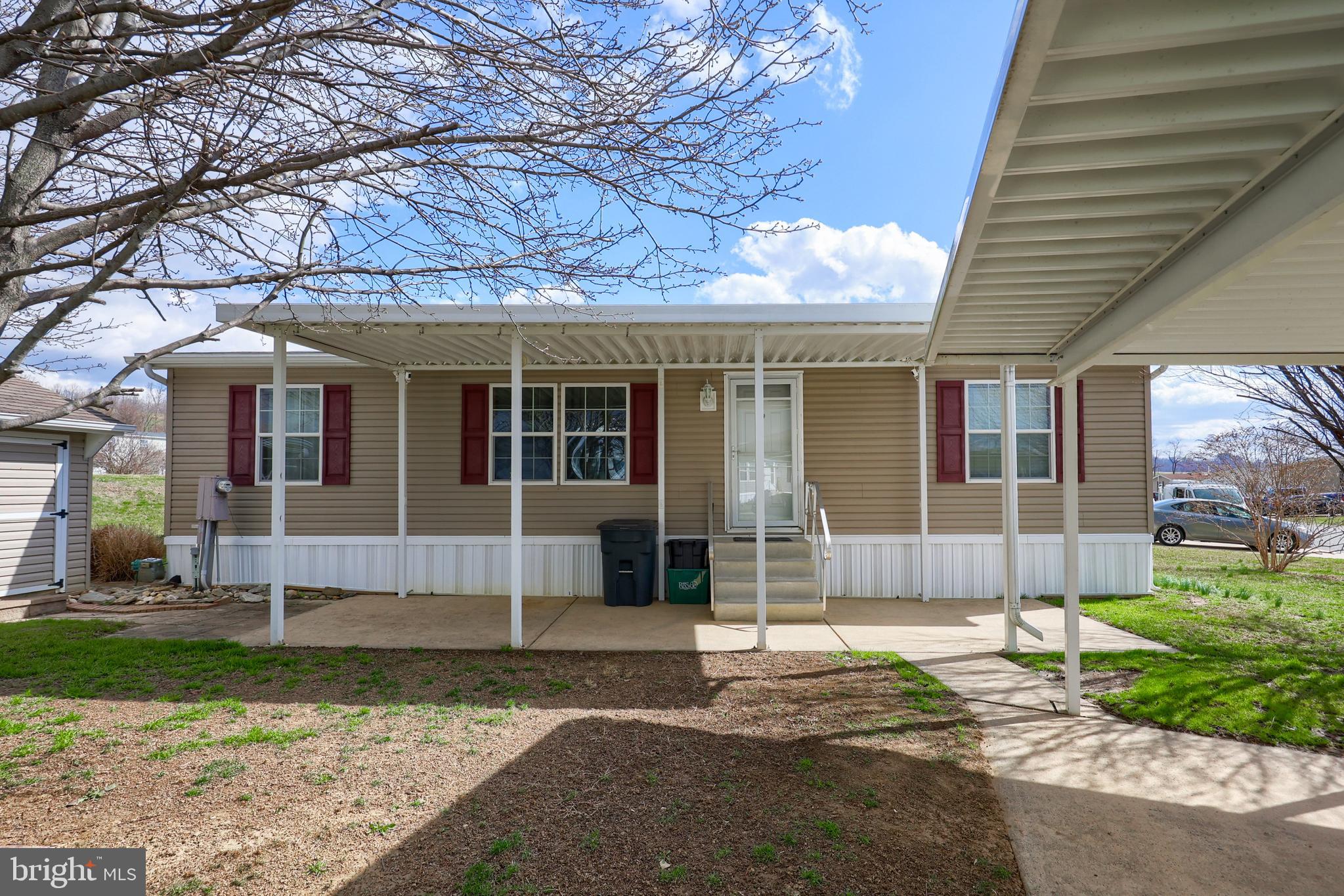 Are you ready to enjoy life in Lancaster’s Southern End? This three bed, two bath home is in a quiet  community surrounded by agricultural land. The park features a community pool for your enjoyment through the summer. The home is outfitted with a generous kitchen and tall ceilings. The skylights add to the available light. The primary bedroom has its own bathroom and shower. Cross the open living room and you have two more bedrooms and a separate full bath. Comforts are provided by natural gas and central air. Park your car under the double carport, avoiding the hot summer sun or clearing the snow off of it in the winter, you have the added benefit of not having to unload the groceries in the rain. If this is the lifestyle that you are looking for, stop by and see what this home has to offer!