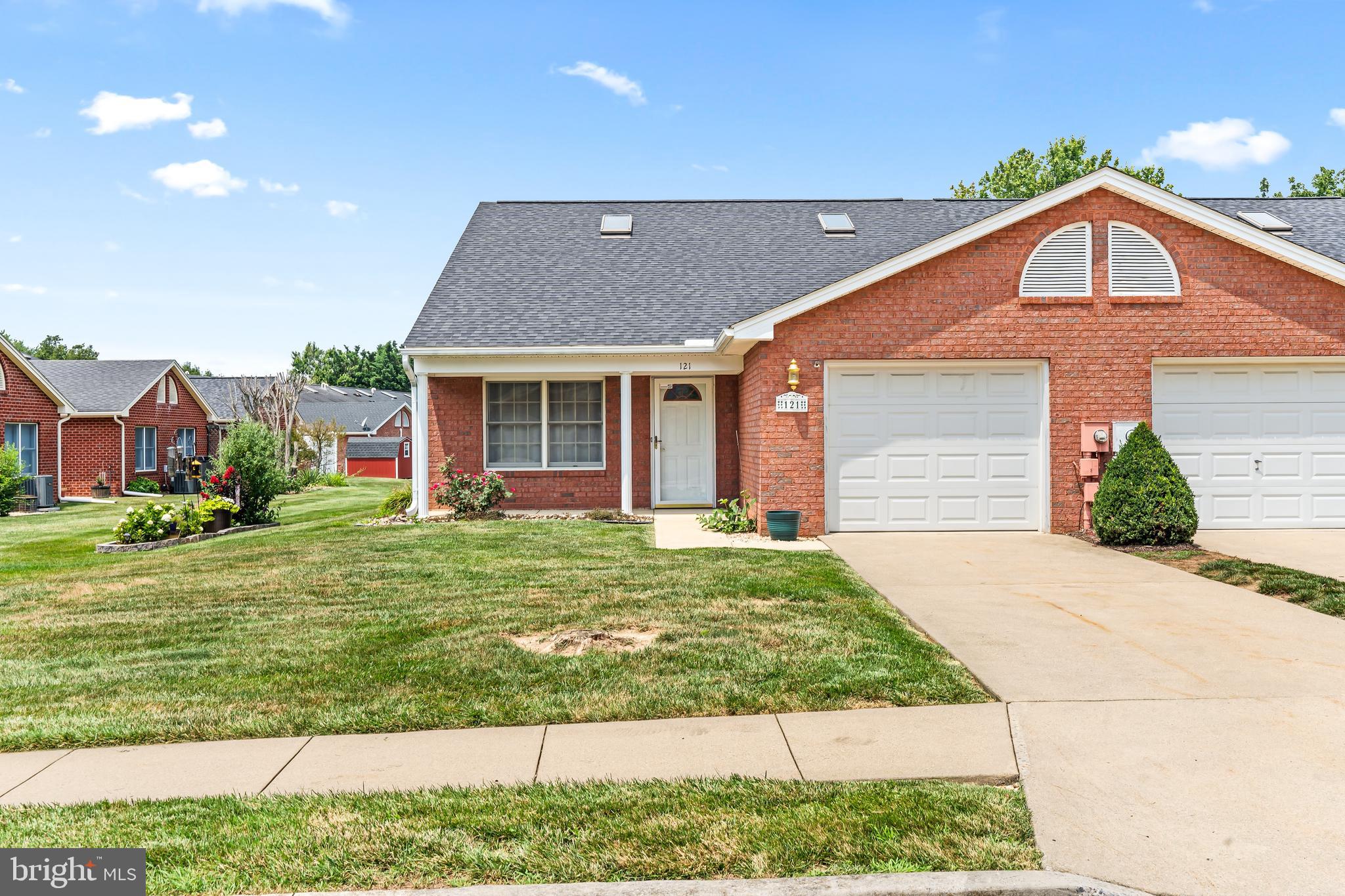 Welcome to this Desirable All brick, Single Level, End unit townhome located in Englebrook Park!   This thoughtfully updated home features a beautiful open-concept floor plan with vaulted ceilings and skylights creating a remarkably bright and spacious feeling.  The large living room area serves as an inviting centerpiece and is anchored by a free standing gas fireplace to bring natural warmth to the space.  The kitchen has been updated with granite countertops, new appliances and garbage disposal within the past 3 years.  Roof is one year old.  Space saving Pocket doors offer separation from the pantry space that leads to the garage entrance.  And, the Laundry is conveniently located and equipped with a newer washer and dryer.  All appliances convey.  The generously sized primary suite features a spacious walk-in closet and private full bath.  The second bedroom has a generous closet with the second full bathroom just down the hallway.  Then, step outside to the large covered patio and enjoy a the peaceful natural setting and lovely community park.  HOA fees include lawn care and snow removal for low-maintenance living. Perfectly located with quick access to I-70, I-81, shopping, dining, and schools.
