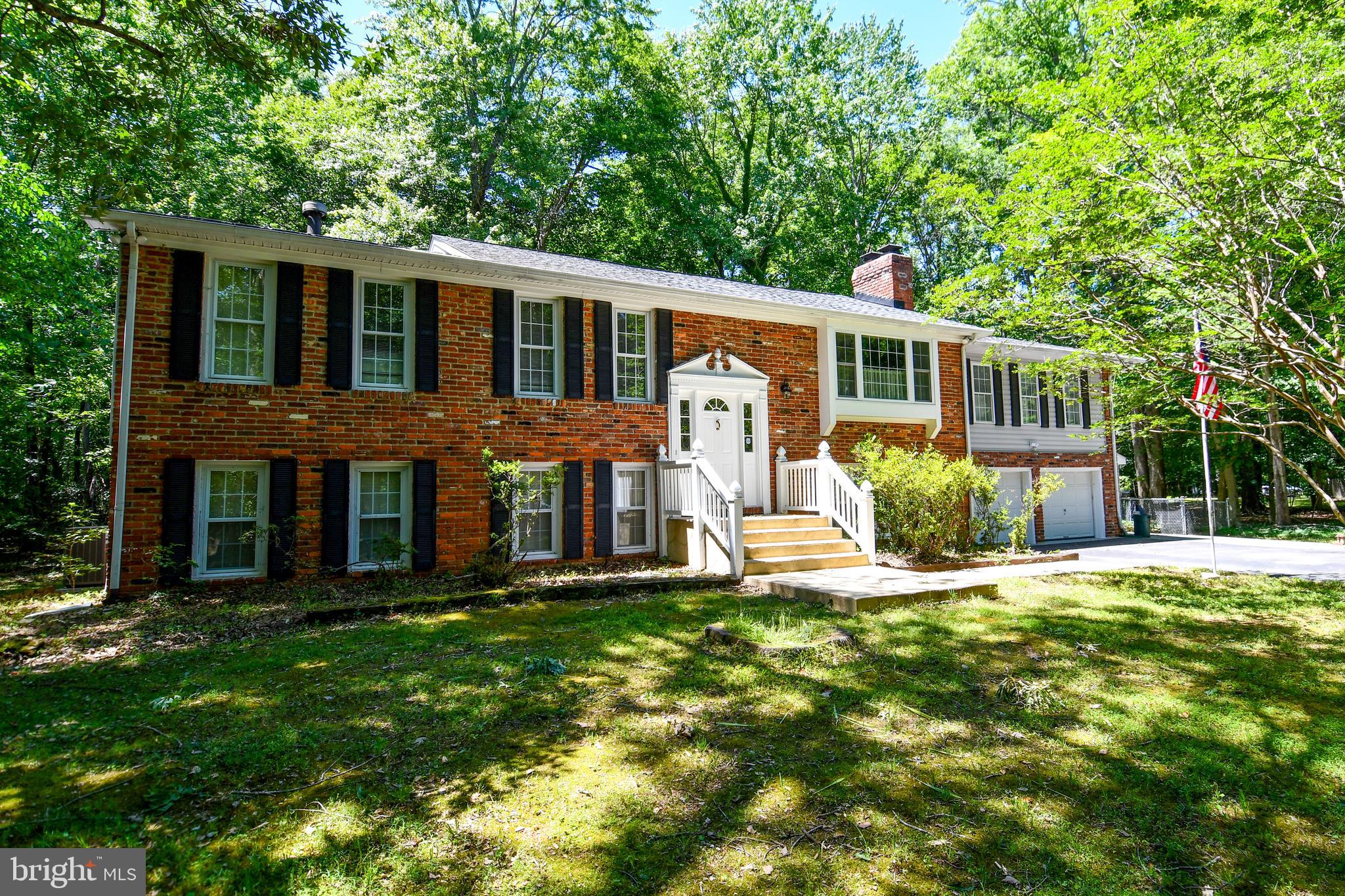 Peaceful Country Home ..SUPER SIZED!! Brick  front Split Foyer. On Beautiful wooded lot... Tender Love & Care- Absolutely everything is here for a lifetime of fabulous living. " A True Value" A wonderful, picturesque family room for entertaining with brick fireplace. Large master. Wonderful gleaming hardwood floors. . Sunlight streams into the beautiful living, large separate dining room.  Beauty and efficiency only begin to describe the magnificent kitchen, complete with built-in -microwave and newer appliances with fabulous family room & fireplace.    Custom patio, beautiful screen porch 16' x 20' for eating crabs and relaxing with your morning coffee. . Large 4th bedroom in the basement, with walk-in Handicapped shower stall. Terrific value in the excellent well cared for home all bathrooms have been updated. *** Manicured & Pampered. Fantastic Condition... Words simply cannot convey the exquisite charm and personality which this fine home radiates.