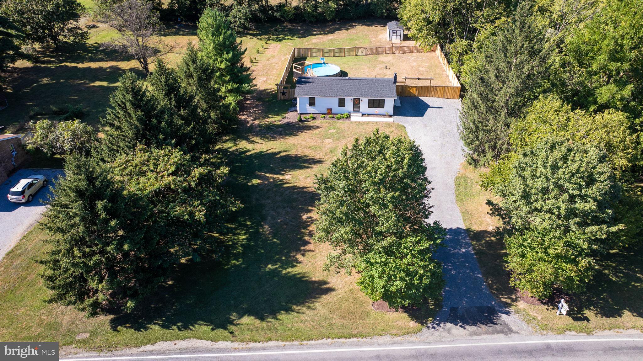 Welcome to this stunning, fully remodeled rancher offering 4 bedrooms and 2 full bathrooms with a thoughtfully designed layout. You’ll find 3 spacious bedrooms and 1 full bath on the main level, along with a fully finished lower level featuring a 4th bedroom, a second full bath, and additional living space -perfect for guests, extended family, or a quiet home office.

Step inside and you’ll immediately notice the modern finishes and clean design, including sleek recessed lighting throughout the home, creating a bright, stylish, and inviting atmosphere in every room.

The home is situated on a flat, private 1-acre lot, offering a peaceful rural setting with no rear neighbors. On the right side of the property is a state-owned wooded parcel, while the back borders open farmland, giving you incredible privacy, scenic views, and a country feel - without sacrificing convenience.

Despite the tranquil surroundings, you’re just a short drive to shopping centers, restaurants, schools, and major commuter routes - the perfect balance of country charm and city access.

Whether you’re enjoying coffee on the back patio, entertaining in the open living area, or working from home in the quiet lower level, this home offers comfort, space, and style at every turn. NEW ROOF, NEW SIDING, NEW HVAC, NEW FLOORING, NEW PATIO,  ALL NEW NEW NEW. Move in and don't worry about a thing!!