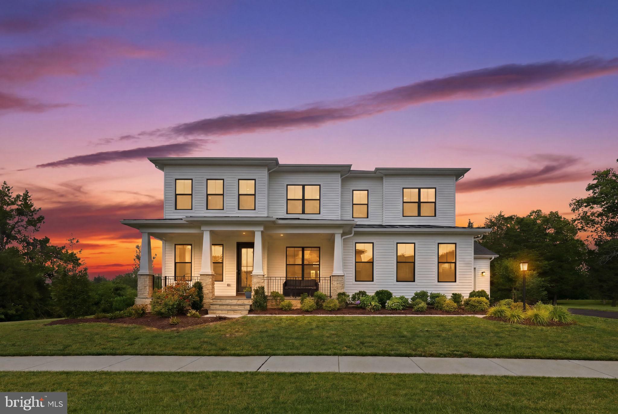 Perfectly positioned on a premium one-third-acre lot backing to protected open space and mature trees, this impressive 5-bedroom, 6.5-bath residence offers over 6,800 square feet of thoughtfully designed living space. A charming flagstone front porch and striking contemporary architecture set the stage for the light-filled interior, where soaring 10-foot ceilings, expansive windows, and rich engineered hardwood floors create an elegant yet inviting atmosphere. Designed for both everyday living and entertaining, the open-concept main level features a spacious great room with a gas fireplace, built-in speakers, and seamless flow into the gourmet kitchen, complete with quartz countertops, upgraded cabinetry, stainless steel appliances, a 5-burner gas cooktop, oversized center island, and walk-in pantry. A sunlit dining area surrounded by walls of windows overlooks the peaceful backyard and wooded views. A private main-level bedroom suite offers ideal accommodations for guests or multigenerational living.

Upstairs, the luxurious primary retreat boasts tray ceilings, dual walk-in closets, and a spa-inspired bath with a freestanding soaking tub, oversized shower, and separate vanities. Three additional bedrooms each feature en-suite baths and walk-in closets, while an open loft provides flexible space for a media room, office, or play area. The finished walkout lower level offers a large recreation room, full bath, and wet bar rough-in, providing endless possibilities for entertaining and relaxation.

Outdoor living is equally impressive. Expansive stacking glass doors open to a covered deck with retractable screens and a gas line for grilling, creating a true indoor-outdoor experience ideal for gatherings throughout the spring, summer, and fall. The professionally landscaped yard is enhanced by a 10-zone irrigation system, while premium upgrades including an 18.92kW solar system, whole-house water filtration, EV charger, CAT6 wiring, and whole-home Sonos audio provide exceptional comfort and convenience.

Lenah Mill residents enjoy resort-style amenities including a clubhouse, fitness center, Splash & Play Pool, tennis and basketball courts, volleyball court, dog park, playgrounds, scenic ponds, amphitheater, and miles of walking trails through nearly 300 acres of green space. Ideally located near Routes 50, 28, and the Dulles Toll Road, the home is minutes from Stone Ridge Village Center, Harris Teeter, and local favorites including Ciro Ristorante, Biryani Grill, and Brew Birds. Outdoor recreation abounds with nearby Hal & Berni Hanson Regional Park, Gilbert's Corner Regional Park, wineries and breweries, and the charming shops and equestrian lifestyle of historic Middleburg. Served by highly acclaimed Goshen Post Elementary, Willard Middle, and Lightridge High School, this remarkable home combines luxury, comfort, and an exceptional lifestyle in one of Loudoun County's premier communities.