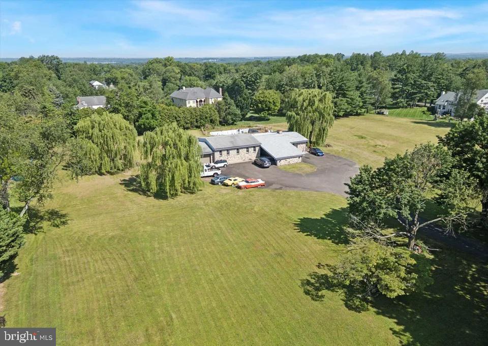Welcome to this exceptional estate offering the perfect blend of space, comfort, and endless possibilities! Situated on approximately 3.12 acres of beautiful land, this impressive property features six spacious bedrooms and five full bathrooms, making it ideal for a large family, multi-generational living, or those who love to entertain. The home boasts a large, inviting living room, a charming breakfast nook perfect for casual dining, and a beautifully designed open kitchen with plenty of space for gathering and creating memorable meals. A stunning spiral staircase leads to the lower level, which offers three additional bedrooms and two full bathrooms, providing excellent flexibility for guests, extended family, or private living quarters. Adding warmth and character to the home are two magnificent stone fireplaces that create a cozy and elegant atmosphere, Outside, you'll 3.12 acres and the rare opportunity of two additional LOTS that can be used for future new construction, investment potential, or expanded outdoor living. an extended driveway with ample parking,