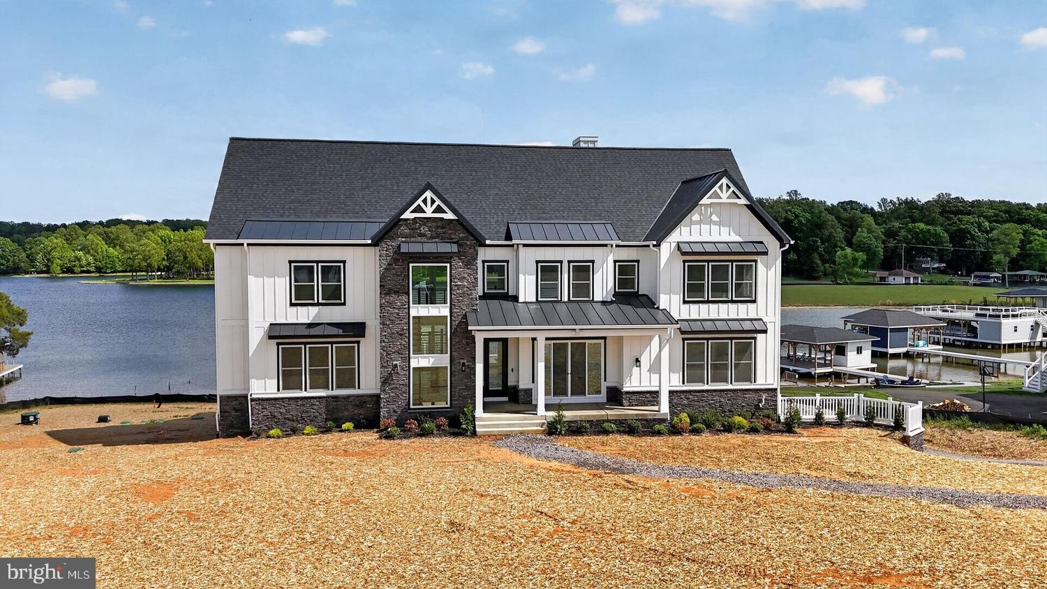 Welcome to Rock Island Landing, Lake Anna's newest subdivision, where new construction meets the epitome of waterfront living. This stunning home, yet to be built, promises a private paradise on a majestic 1.10-acre lot in Lake Anna, Louisa County.

Immerse yourself in the allure of this unique waterfront residence, boasting 175 feet of breathtaking waterfront and a flat, comfortable elevation that invites stunning views and incredible sunset moments. With direct lake access and a beautiful private yard, this property is designed for those who appreciate the finer things in life.

No detail, whether grand or small, has been overlooked in the design and construction of this home. With over 6,102 square feet of living space on all three levels, this masterpiece offers 8 bedrooms, 5 full baths, 2 half baths, and a host of luxurious features.

The main level welcomes you with an open floor plan featuring 10' ceilings, a dramatic two-story ceiling in the great room and dining area, screened porches, and a deck perfect for large-scale entertaining. The modern-styled kitchen is equipped with premium stainless steel appliances and quartz countertops.

The luxuriously appointed master suite on the main floor boasts a stunning master bath with marble accent wall tiles, a freestanding bathtub, a luxurious shower, and a private screened porch overlooking the lake. Two additional spacious bedrooms with a full bath, one featuring a private screened porch, and a convenient first-floor laundry complete the impressive main-floor living space.

The third level offers three bedrooms, two with balconies overlooking the lake, a sitting area, 9-foot high ceilings, and an office space. The expansive lower-level walkout is an entertainment haven with a full kitchen/bar. These two additional bedrooms could serve as an office or media room, a fireplace, and multiple decks and screened-in porches.

This waterfront haven on the private side of Lake Anna allows you to customize the finishing touches to make it uniquely yours. Choose your interior and exterior finishes, colors, and upgrades, including the option for an elevator.

Don't miss the opportunity to own a piece of paradise. Call the real estate agent for more information on other floor plans and available waterfront lots. 





Other floor plans and waterfront lots are available.