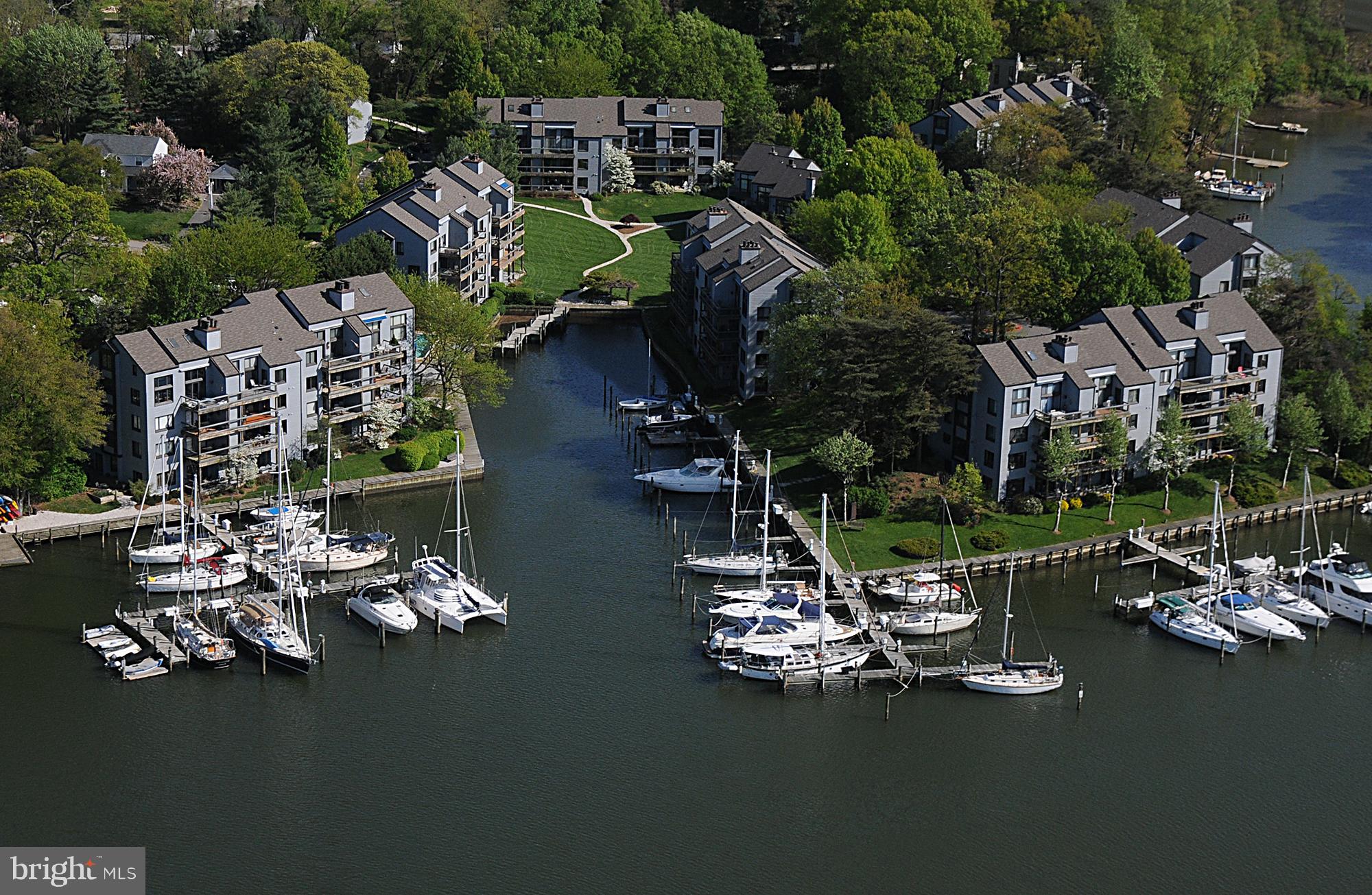 Spectacular waterfront terrace comprised of  1800  + - sq. ft of open and inviting floor plan.  Sunset views on Spa Creek.  Fabulous chef's kitchen with Volakas marble countertops.  Viking appliances with induction cooking. Butler's pantry featuring a workstation, and easy access to the adjoining family areas for casual meals or large events.  V-groove shiplap accent walls throughout.  Gather around the fireplace, topped with a rich fifteen-foot maple mantel that anchors the space with timeless charm. Exceptional crown molding.  Primary bedroom with access to your private, oversized 40 ft deck.  Luxury bath with radiant heated floors.  Beautiful tongue and groove maple floors. The stone courtyard is framed with landscaping and a serene Zen koi pond. The perfect spot to grill your summer vegetables and burgers for outdoor dining and entertaining.  This condo includes a deeded B46  30 X 15 boat slip with MLW 3-4 ft. just steps from your front door.  Storage shed and additional Basement storage locker. Observe blue herons, egrets, ducks, and bald eagles from your garden terrace. There are boat slips available depending on size and water depth. The cost of $62 per foot of overall boat length per year. Most slips are 15-18 wide. Depth ranges 6-8 ft MLW. Power and water included. The marina includes 34 slips owned by the Shearwater Association, as well as 28 slips that are deeded to Condominium Owners. Other facilities owned by the Association include 13 spaces for dinghies and 42 spaces for kayaks. Electricity and water are available to all users of the marina facilities at no charge. Dinghies $195 per year - Kayaks $100 per year. LCE slip owners may also rent their slips to other condominium owners or tenants. Contact the Dockmaster for all information regarding resident and guest slip availability. Spa Creek is one of the most sought-after waterways in all of Annapolis, taking you to downtown Ego Alley. Perfect spot to watch the Parade of Lights in December, a tradition in Annapolis. Best of all, it's nestled along the waterfront, offering peaceful mornings and golden hour views and the kind of lifestyle that turns every day into a getaway. Come live and enjoy this wonderful waterfront lifestyle and AMAZING SUNSETS! Breathtaking at every turn, this condo is truly one-of-a-kind.