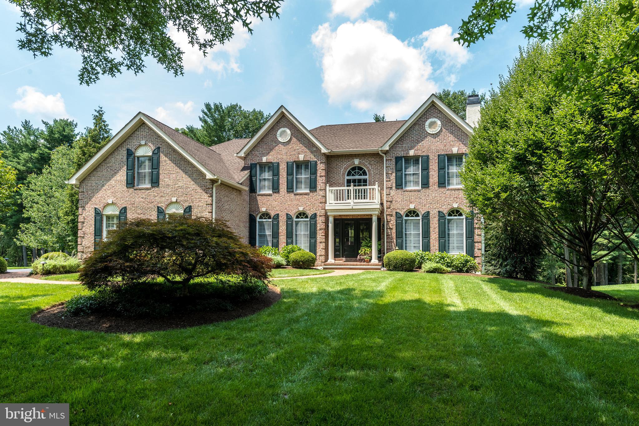 Welcome home! Nestled on a tranquil cul-del-sac street in Buckingham, this expanded Federal Madison Model masterfully blends comfort and style. The stately brick exterior is surrounded by lush plantings and a wooded backdrop. An atmosphere of refined luxury unfurls in every corner of this 4 bedroom, 4½ bath home boasting 9-foot ceilings on the main level, wood floors, upgraded woodwork and plantation shutters throughout most of the home. Double doors open into a grand 2-story foyer, drenched in natural light. Transom windows and pristine white woodwork add a touch of classic grace to the entrance. In the living room, a fireplace with a raised brick hearth invites cozy gatherings, while wainscoting adds an extra layer of sophistication. Across the entrance hall, the dining room, adorned with a coffered ceiling, sets the stage for memorable dinner parties. Just steps away, the kitchen, remodeled with care and attention, features white cabinetry, a charming beadboard ceiling, double wall ovens, leathered quartzite counters with a custom tile backsplash, and a sprawling center island with a gas cooktop and overhang for seating. A window over the Shaws farmhouse sink frames a picturesque view of the meticulously manicured lawn, which gently slopes down to meet a serene treeline. Open to the kitchen, the breakfast room offers a warm and inviting space to enjoy your morning coffee. From here, step out onto the Trex deck with a pergola to relax and savor the beauty of nature in your private sanctuary. The 2-story family room, complete with another wood-burning fireplace, is a gathering place for cherished moments, while the study invites quiet moments of inspiration with a built-in bookcase. An antique door slides to separate the kitchen from the laundry room, where the oversized 3-car garage may be accessed. Rich wood floors continue up the butterfly stairs to the second floor with an overlook, wainscoting, and built-in cabinetry. The primary bedroom suite is a haven of tranquility, featuring a trey ceiling, a den/sitting room with built-ins, an enormous walk-in closet (20' x 10'), and a luxurious spa-like bath remodeled to perfection. Unwind in the soaking tub or rejuvenate in the oversized tiled shower with seamless glass doors. Three additional bedrooms await, including a Prince/Princess Suite, featuring built-ins and its very own full bathroom, while the other two generously-sized bedrooms share a Jack 'n Jill bathroom, fostering harmony for the whole family. The finished walk-out basement offers a game/recreation area, separate bonus room and a full bathroom. There is even a food-prep area featuring a sink, microwave, and undercounter beverage cooler. French doors open to a paver patio, perfect for entertaining or relaxing in style. This home is a masterpiece of design and attention to detail, where meticulous upkeep and quality craftsmanship shines through at every corner. Some of the more recent improvements are: roof and gutters replaced in 2018, HVAC replaced 2015, and the water heater replaced in 2020. Convenient access to major commuter routes and the train station eases your daily commute, while nearby Hansell and George Bush Parks provide endless outdoor adventures. Historic Doylestown Borough, with charming shops, dining, and cultural events, is just a quick 5-minute drive away. Enjoy the award-winning Central Bucks School District or choose from many of the prestigious private schools nearby. These photos capture the early summer beauty of this property, but don't miss the chance to witness the vibrant fall foliage in person. Schedule your private tour today and embrace the lifestyle you've always dreamed of! Note: Seller is a PA licensed Realtor.