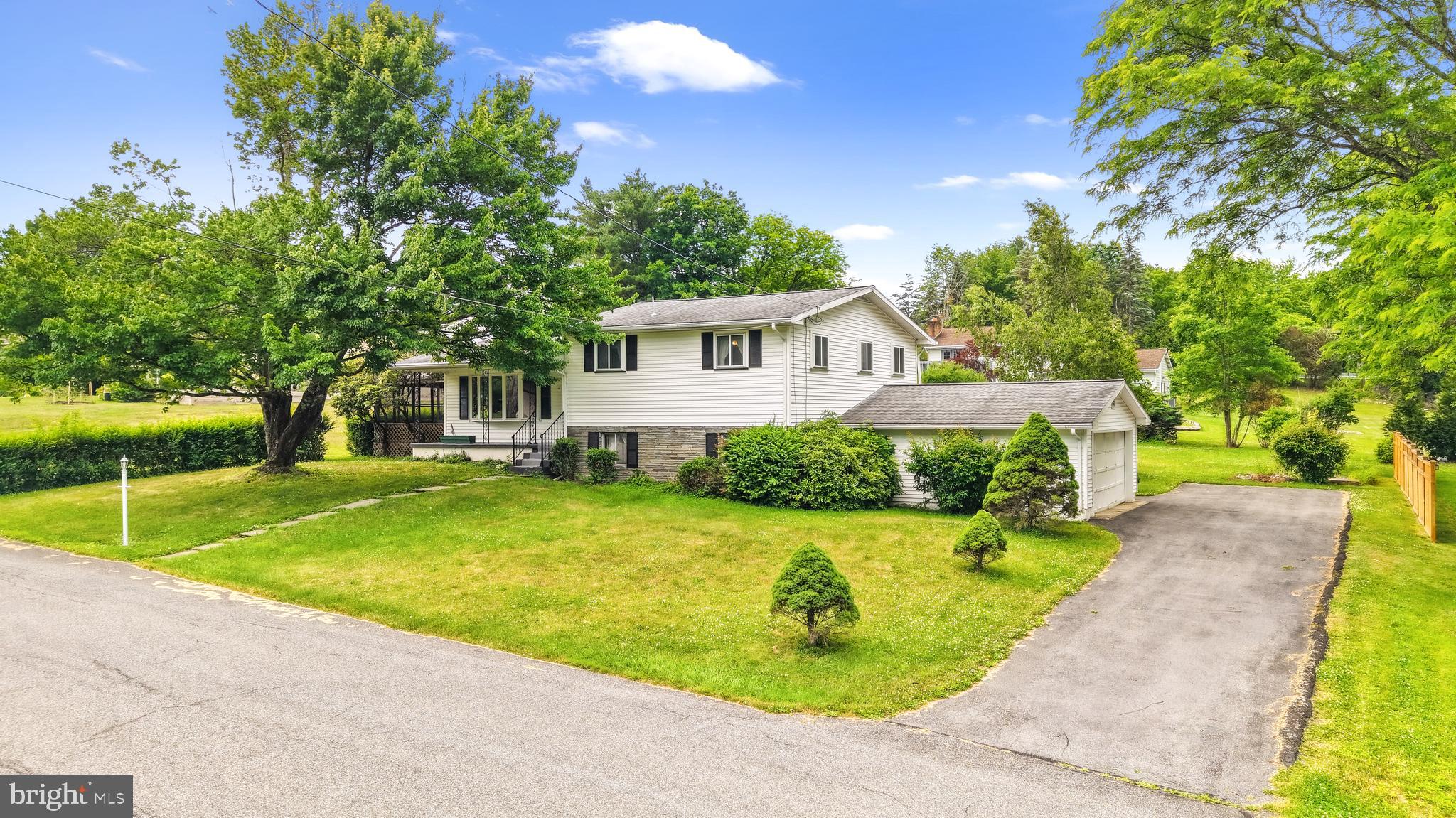 Looking for a home you can move right into before the school year begins? This well-maintained split-level home has one of the most convenient locations near the heart of Stroudsburg. Make your morning routine much easier with the School directly across the street from the neighborhood, and save time on your commute just minutes to Route 80 and everything nearby. Offering 3 bedrooms, 1.5 bathrooms, and a functional multi-level layout, features a bright open living room and dining area with vaulted ceilings, a wood-burning fireplace and a neutral canvas to make your own. The second level includes all three bedrooms, a full bathroom, a half bath en suite, and a walk-in closet within the Primary Bedroom. The lower level expands the home's living space with a spacious family room with a built-in bar area, laundry area, and direct access to the large, attached 2-car garage. Expand to the outdoors to sip coffee on the welcoming covered front porch, and enjoy dinner and parties into the large screened porch, with a flat, sunny, cleared yard. With Convenience inside, out, and nearby, your prime location near shopping, dining, schools, and major commuter routes, with NO HOA, this property offers a great opportunity to enjoy a neighborhood setting with easy access to everyday amenities. Ask how to receive up to $5,000 lender credit towards closing costs or lowering your interest rate!