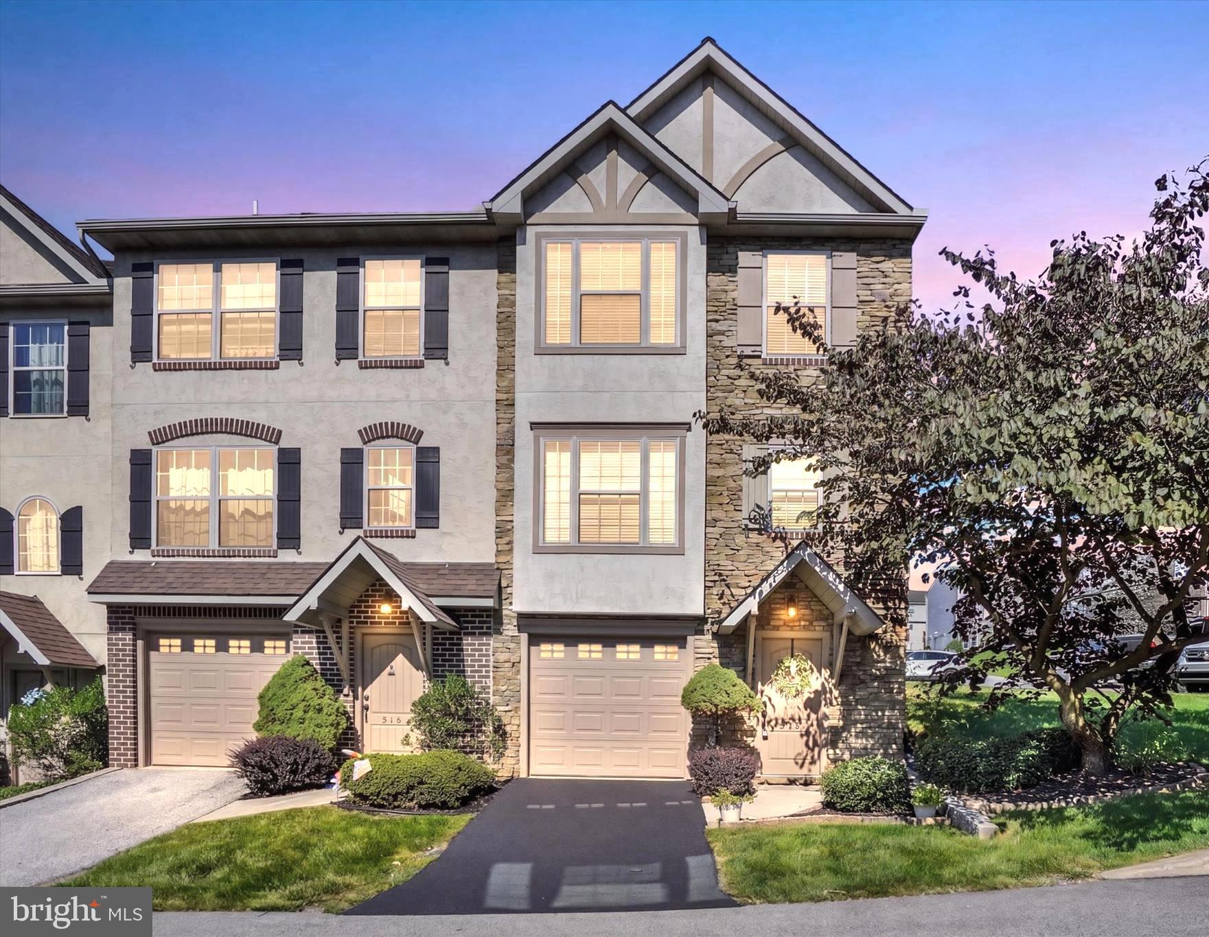 For those who appreciate the finer things but prefer to leave the demands of exterior maintenance and yardwork behind, this exceptional Carriage Crossings residence offers the perfect balance of luxury, space, and convenience. This is not your typical townhome.

Ideally positioned as an end unit in the desirable Carriage Crossings community and located within the Dallastown Area School District, this beautifully appointed condominium townhome offers approximately 2,832 square feet of finished living space across four levels. With three bedrooms, two full baths, one half bath, an attached garage, multiple gathering spaces, and an impressive collection of upscale finishes, the home delivers the comfort and refinement more often associated with a luxury single-family residence.

A private entrance framed by handsome stonework welcomes you into a thoughtfully designed interior where elegance and functionality blend seamlessly. The end-unit setting provides additional windows, enhanced privacy, and a spacious side and rear lawn bordered by mature trees. A soft neutral palette, crown molding, upgraded lighting, and stylish finishes throughout create a polished yet inviting atmosphere.

The main living level is especially impressive. Graceful rounded archways add architectural character and a custom feel rarely found in a townhome, while the spacious living room flows effortlessly into the kitchen and dining areas. The beautifully appointed kitchen features abundant white cabinetry, granite countertops, stainless steel appliances, a decorative tile backsplash, pantry storage, and an expansive contrasting center island offering generous workspace and seating.

The adjoining dining area is truly extraordinary, anchored by a dramatic custom-style fireplace with an oversized architectural mantel and flanking display shelves. Distinctive lighting, crown molding, and direct access to the rear deck create an elegant setting for intimate dinners, holiday gatherings, and relaxed evenings at home. The deck overlooks maintained lawn and mature trees, providing a peaceful extension of the indoor entertaining space.

Upstairs, the expansive primary suite offers abundant natural light, space for a sitting area, and a large walk-in closet. The private en-suite bath features a double-bowl vanity, corner soaking tub, separate shower, and a spacious layout designed for relaxation. A generously sized second bedroom, additional full bath, and conveniently located laundry complete this level.

The third floor adds exceptional flexibility with a large family room, an additional bedroom, and a walk-in closet. This level is ideal as a private guest retreat, home office, media room, studio, or flexible living space.

The finished lower level provides even more room to gather and unwind, with recessed lighting, durable flooring, storage, and a built-in serving and bar area. It is perfectly suited for entertaining, movie nights, a game room, fitness space, or second home office. The attached one-car garage adds everyday convenience.

A new HVAC system was installed in 2024. The condominium association provides maintenance of many major exterior and common-area components, including the roof, exterior siding and trim, common landscaping, roadways, and designated snow removal, allowing you to enjoy the beauty and space of the home without many of the responsibilities associated with a traditional single-family property.

If you appreciate luxury, thoughtful design, and the finer details but prefer a more convenient, low-maintenance lifestyle, this exceptional end-unit residence may be exactly what you have been waiting for.