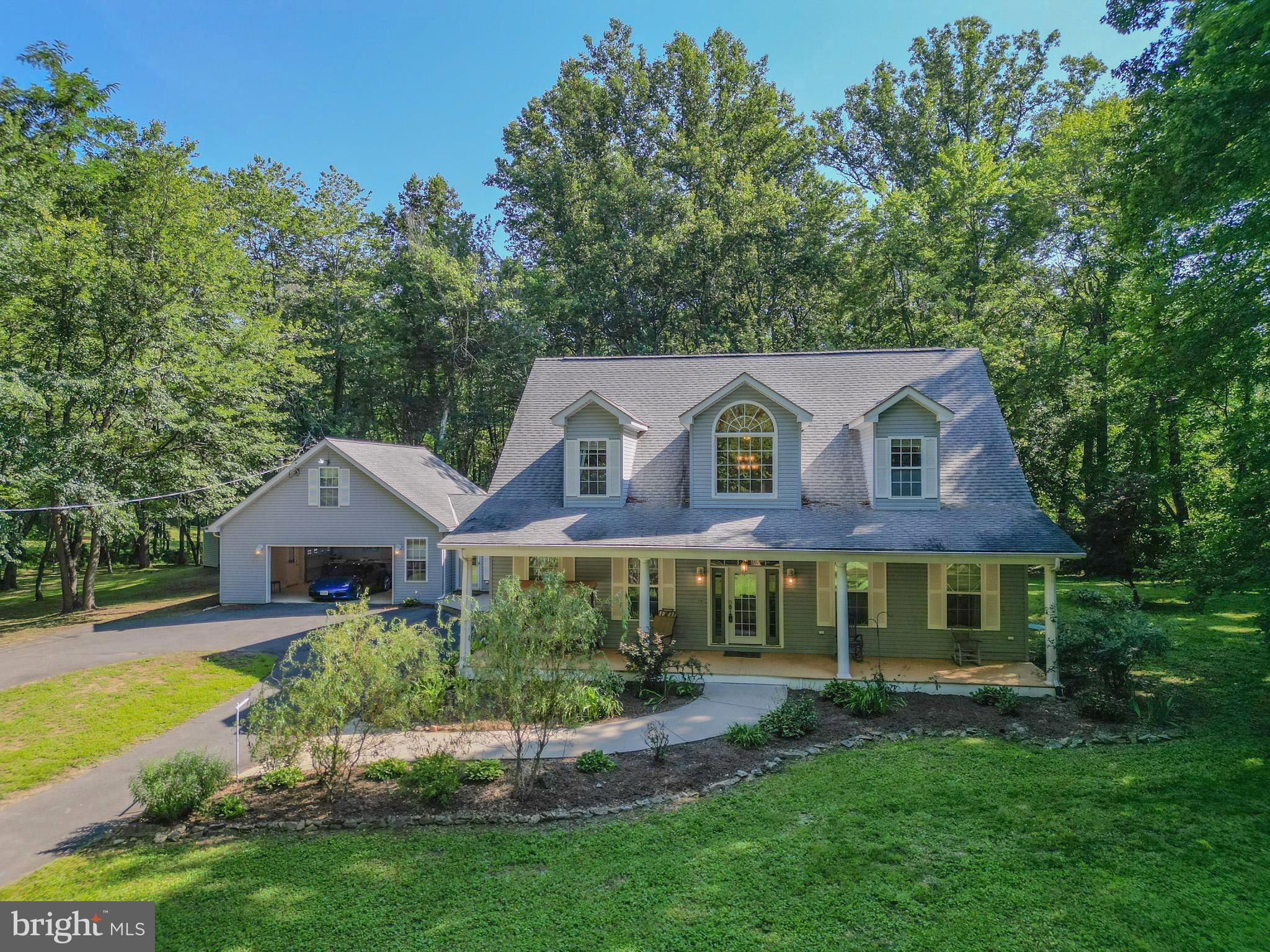 Located at 14555 Lee Highway, Amissville, VA, this exceptional home offers the perfect balance of peaceful country living and convenient access to Northern Virginia. Set on 5 private, wooded acres, the property features over 4,400 square feet of beautifully designed living space, ideal for relaxing, entertaining, or simply enjoying the surrounding natural beauty.
Inside, you'll find a spacious layout with 9-foot coffered ceilings, a formal dining room, two full kitchens,  and garage apartment, providing flexibility for entertaining or multi-generational living. The main-level owner's suite is a private retreat with a marble bathroom, jetted soaking tub, oversized dual shower, large walk-in closet, and laundry.
Thoughtful upgrades include granite countertops, stainless steel appliances, crown molding, surround sound, energy-efficient Low-E windows, durable 2x6 construction, and dual Ethernet and HD cable wiring throughout.
Outside, enjoy a fenced backyard, private deck, paved circular driveway, and the privacy of your own wooded setting. Recent improvements include new epoxy garage flooring, a new 3.5-ton heat pump system, an 18,000 BTU garage mini-split, and upgraded whole-house water filtration and treatment systems.
Whether you're looking for a full-time residence or a peaceful weekend retreat just 60 miles from the nation's capital, this Amissville property offers the perfect blend of space, privacy, and modern comforts to enjoy the very best of Virginia's countryside. Conveniently located just 10 miles from the historic village of Washington, Virginia, and only 21 miles from Shenandoah National Park, you'll have easy access to renowned dining, boutique shopping, hiking, wineries, and endless outdoor recreation while still enjoying the tranquility of country living.
