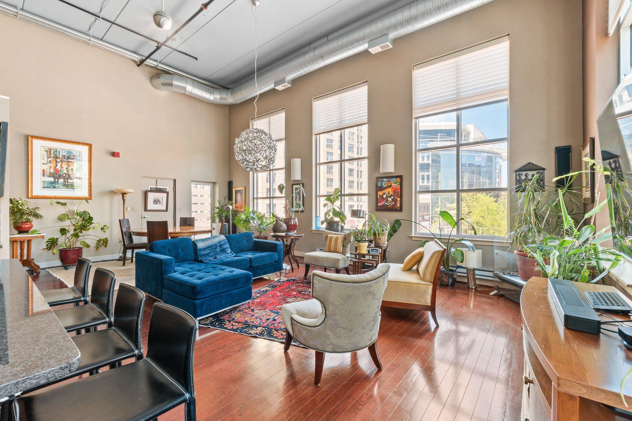 Rare corner unit and one of the largest floorplans in the building, this two story loft in the heart of downtown Silver Spring is enhanced by a loft expansion and features dramatic floor to ceiling windows that highlight the home’s impressive volume and abundant natural light. Soaring ceilings and an open concept layout create spacious living and dining areas that are bright, airy, and highly functional for both everyday living and entertaining.

In addition to a private den, the newly expanded upper level loft overlooks the main living area, enhancing the home’s open, architectural character. These flexible spaces are well suited for a home office, reading area, meditation, creative use, or guest accommodations.

A private balcony extends the living space and provides an inviting outdoor retreat.

Located just blocks from vibrant downtown Silver Spring, the home offers convenient access to the Metro train hub, dining, shopping, and entertainment, supporting a highly walkable, commuter friendly lifestyle.

Additional features include in unit laundry and an assigned parking space.
