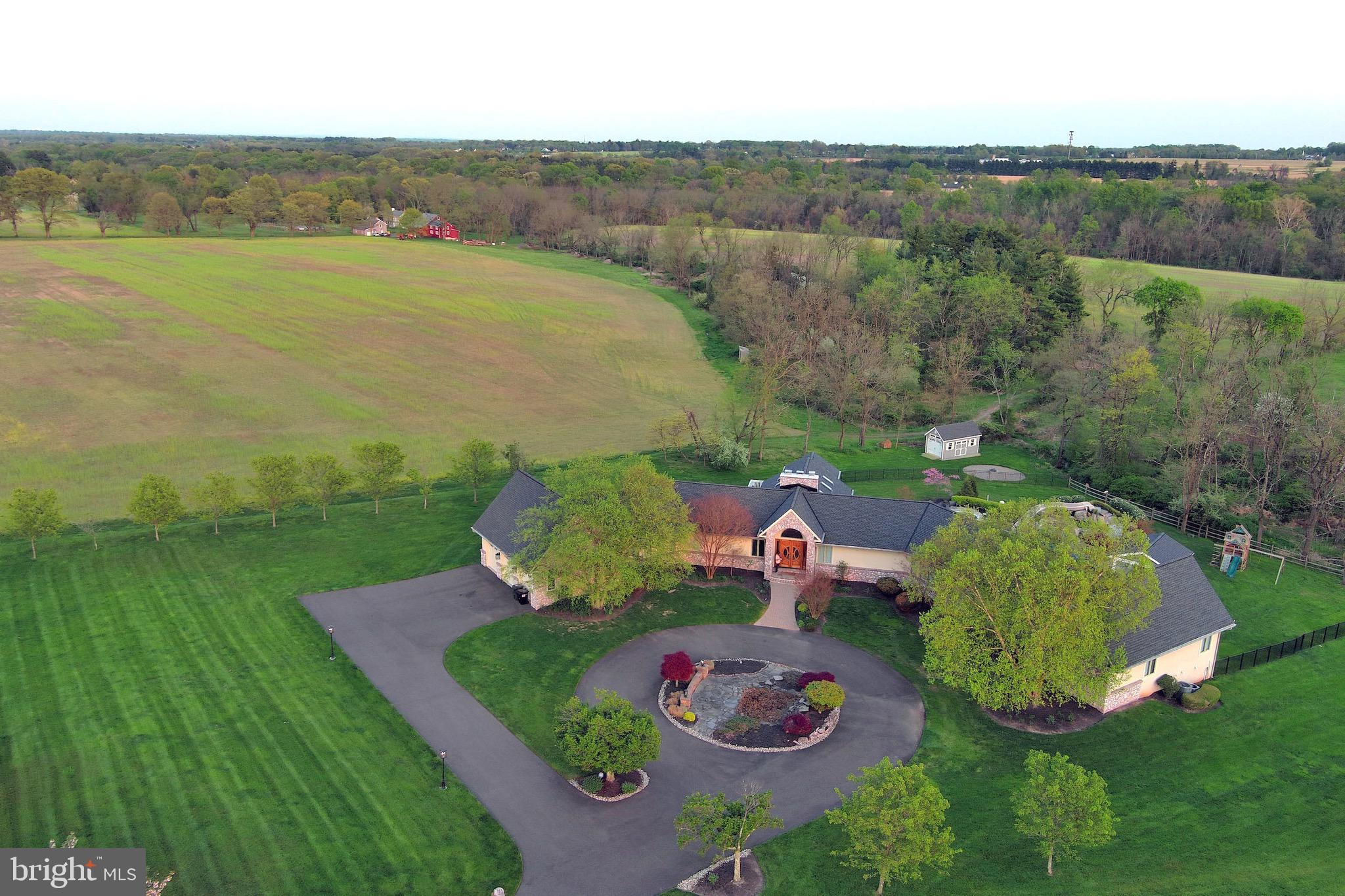 <<<<<<ALL FURNITURE IS INCLUDED IN THE SALES PRICE>>>>>>>>

Welcome to this bright and spacious 5-bedroom, 6 1/2-bathroom home nestled on a charming lot (3.24 acres) adjacent to the rustic Bucks County countryside. With close to 9,000 sq ft (approximate figure coming from prior listing ) of living area spread over two floors, this open floor plan home offers ample space for comfortable living.  

As you step inside, you’ll be greeted by high cathedral ceilings adorned with skylights and elegant chandeliers, creating a dramatic and sun-drenched ambiance in the great room. The focal point of the room is the stunning two-story stone fireplace, perfect for cozy evenings with loved ones.  The southern-facing Sunroom is a true retreat, offering breathtaking views of the tree line and serving as a year-round sanctuary. Step outside onto the large deck and soak in the serene surroundings, ideal for hosting gatherings or simply enjoying the outdoors.

The Kitchen is a chef’s dream, boasting an abundance of cabinets, granite countertop prep space, and a granite island bar. Equipped with top-of-the-line Wolf appliances, this kitchen is perfect for culinary enthusiasts. There’s also a separate eat-in area, making it a perfect spot for casual meals or morning coffee.

Down the stylish curved stairs alongside the exposed stone to the finished lower level which walks out to the back patio and pool. A well-appointed game room with full wet bar awaits including full sink, and dishwasher. The adjacent TV/Media room area is generously sized and enjoys its own gas fireplace. A full bathroom is located right off the door to the patio offering a convenient spot to come in from the pool.

Downstairs, you’ll find a sprawling lower level that includes a movie-like sound system in the living area. This entertainment space is perfect for hosting movie nights, game days, or simply enjoying your favorite music in a state-of-the-art audio environment.

There are a total of 6 1/2 bathrooms in this home, providing convenience and privacy for all residents and guests. Each bathroom is beautifully designed with high-end fixtures and finishes, ensuring a luxurious experience. Throughout the house, you’ll enjoy the convenience and luxury of the Sonos audio system, allowing you to effortlessly enjoy your favorite music in every room.

In addition to its already impressive features, this home also offers several handicap-accessible amenities. The garage includes a handicap-accessible entrance, allowing for easy access into the home.  For added convenience, a beautifully designed custom elevator is installed, providing accessibility to both floors of the house. This ensures that everyone can move freely and comfortably throughout the home.

There are two handicapped bathrooms, one located upstairs and another downstairs, designed with accessibility in mind. These bathrooms are equipped with features such as roll-in showers, ensuring ease of use for individuals with mobility concerns.  The custom-designed pool also features a roll-in entrance, providing accessibility for individuals with mobility challenges. This allows everyone to fully enjoy the refreshing oasis and the fun of the pool. These handicap-accessible features add an extra level of convenience and inclusivity to the home, ensuring that it can accommodate the needs of all residents and guests.

One of the highlights of this property is the beautiful pool with a waterfall and slide, providing a refreshing oasis on hot summer days.  Adjacent to the pool is a massive cabana and outdoor kitchen that adds to the resort style feel of this home.  Situated on almost 4 acres, there’s plenty of space to relax, play, and explore.  The owners spared no expense when it comes to maintenance on the property.   In 2021 a brand new roof was installed over the entire home. 
                   <<<<<<<<View  the custom website with drone footage in virtual tours>>>>>>>>>
