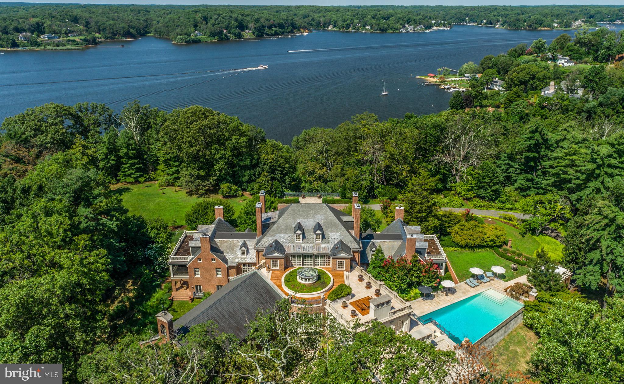 THE FRIARY   a Trophy property in a league of its own! Set on 23 private acres overlooking a gracious bend of the Severn River with 1,500ft of prime waterfrontage, just minutes from downtown Annapolis and less than an hour from the nation's capital, lies one of the most distinctive estates offered for sale on the East Coast.  A true architectural masterpiece, this exquisite 35,000+ sqft residence, is the result of a mammoth and complex renovation that brought it back to its classic Georgian style yet with an acknowledgment of the owner's contemporary tastes and interests. Formerly a Capuchin monastery, this stately brick structure offers modern amenities for comfortable family living yet easily accommodates elegant grand scale entertainment and private events. The attention to detail and emphasis on proportions and craftsmanship are unparalleled. The exterior features spectacular 270 degree river views, nine car garage, roof garden, pool pavilion, 60 feet infinity edge pool, tennis court and direct access by funicular to a 6 slip private dock with 10' MLW and boat lift.  Step into the main core of the home, where 18th-century elements, like original heart pine floors & foyer arch moldings, have been flawlessly preserved. A cleverly designed limestone rotunda containing a conservatory & atrium lead to either of the house’s wings: the impeccably appointed guest wing with spacious common room, or the chapel-turned-ballroom with sweeping limestone fireplace, herringbone teak floors, & arched double doors with a picturesque terrace beyond. The extraordinary estate contains a total of seven bedrooms, eight bathrooms and eighteen fireplaces, formal dining room and formal parlor, commercial size gourmet kitchen, over sized ballroom, conservatory, family room, library, music room, indoor spa, game room, wine cellar, catering kitchen, work shop, and a secret vault. Additional structures on the property include a three bedroom, two bath-guest/staff house, an Asian tea house and mechanical facilities. Only minutes from Washington D.C. and multiple international airports, this elegant and opulent property is worlds away from the hustle and bustle of everyday life yet offers an easy commute to several major metropolitan cities.  Unmatched opulence and privacy awaits on the Severn River!